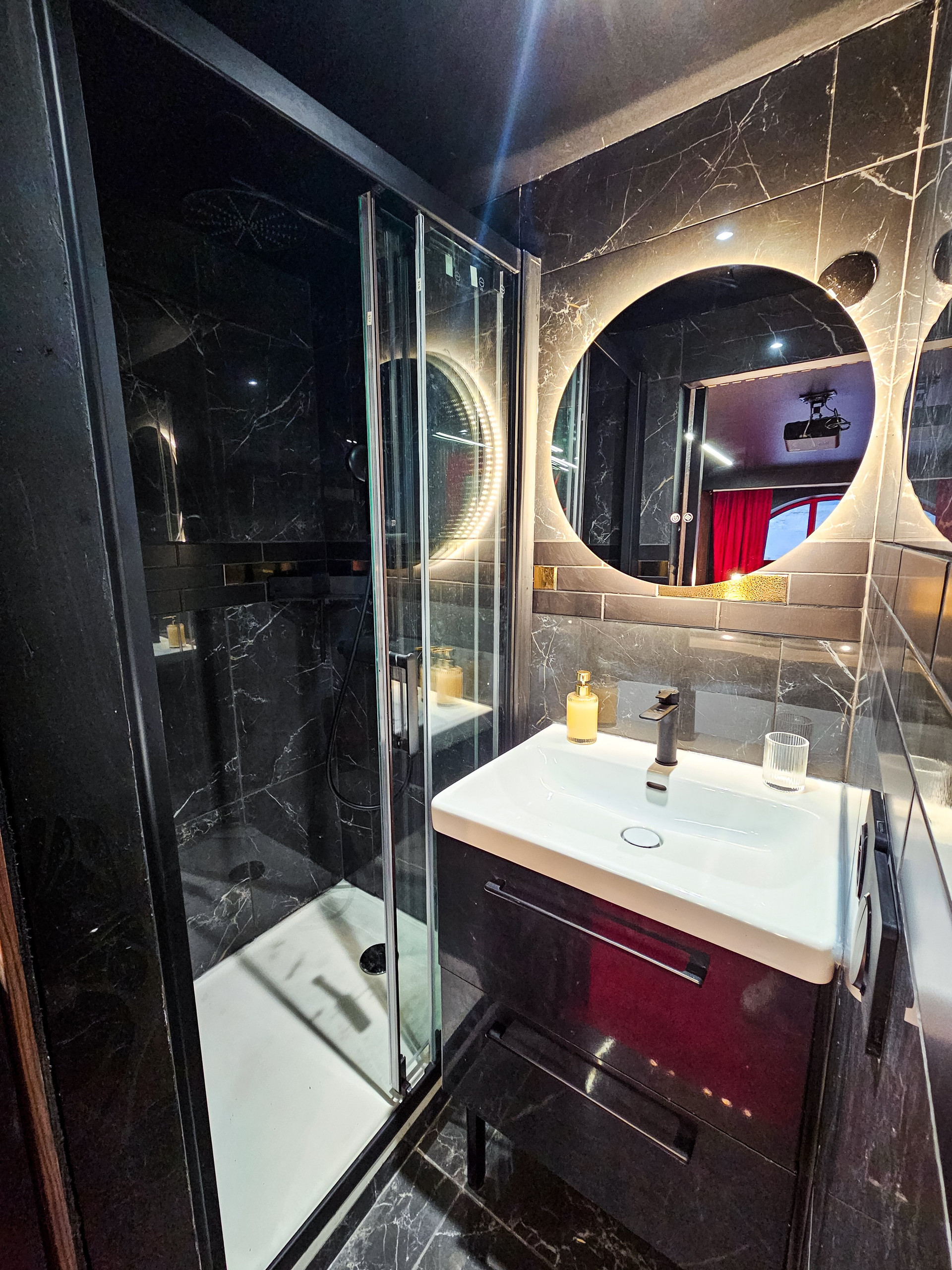 Bathroom with shower and mirror