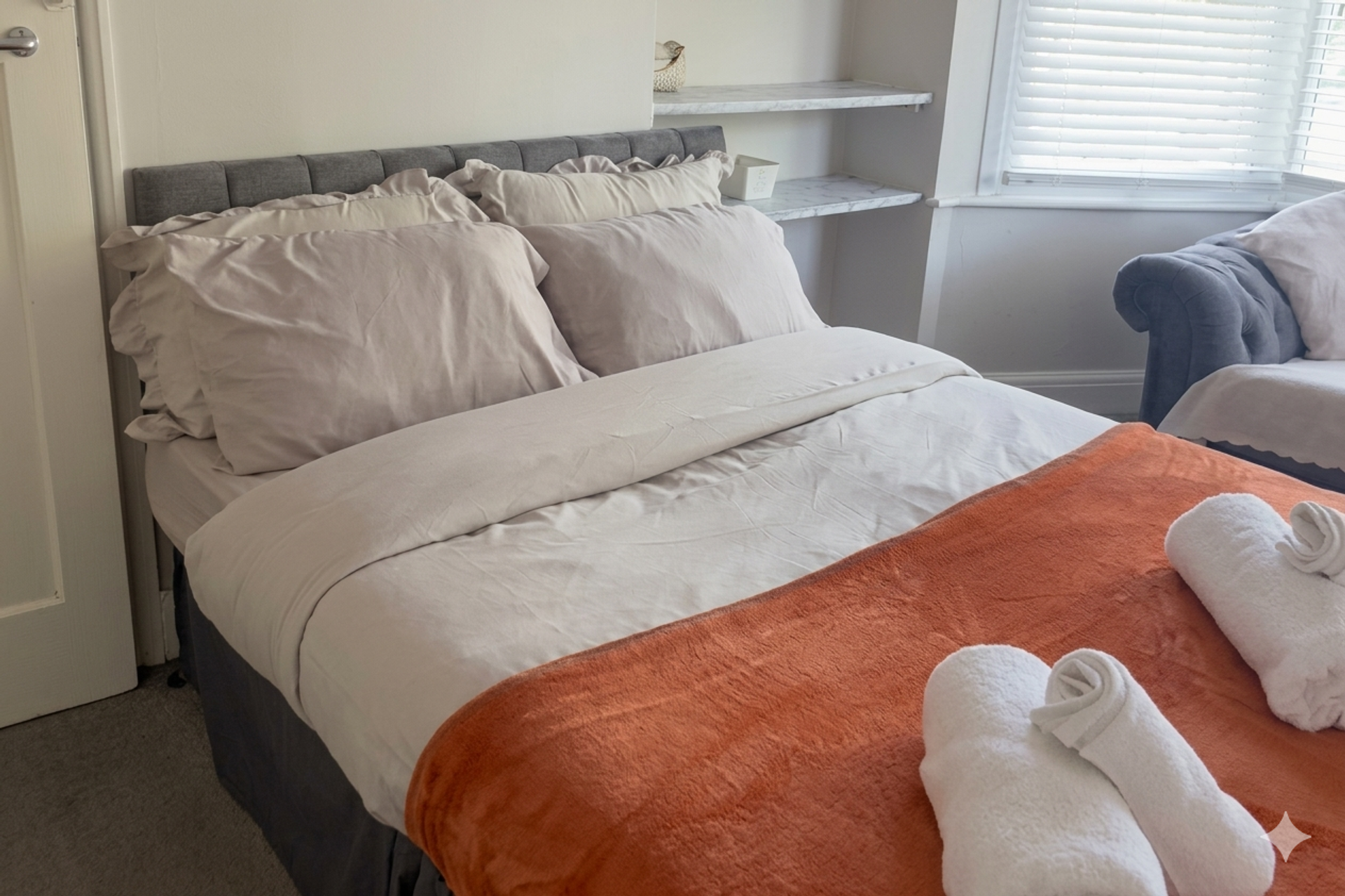 Double bedroom with orange throw