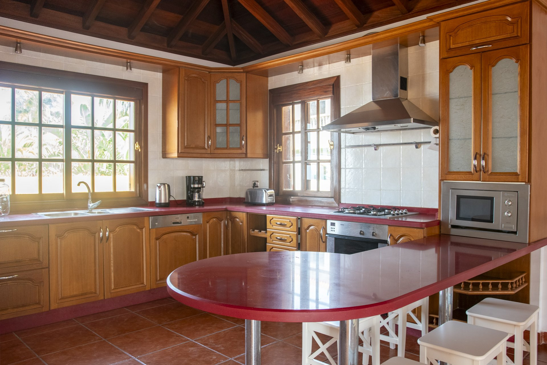 Traditional wooden kitchen with red counters