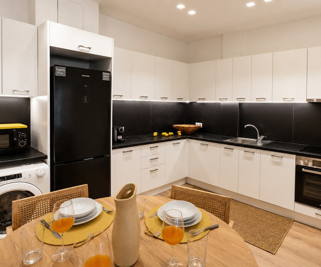 Kitchen with dining table and appliances