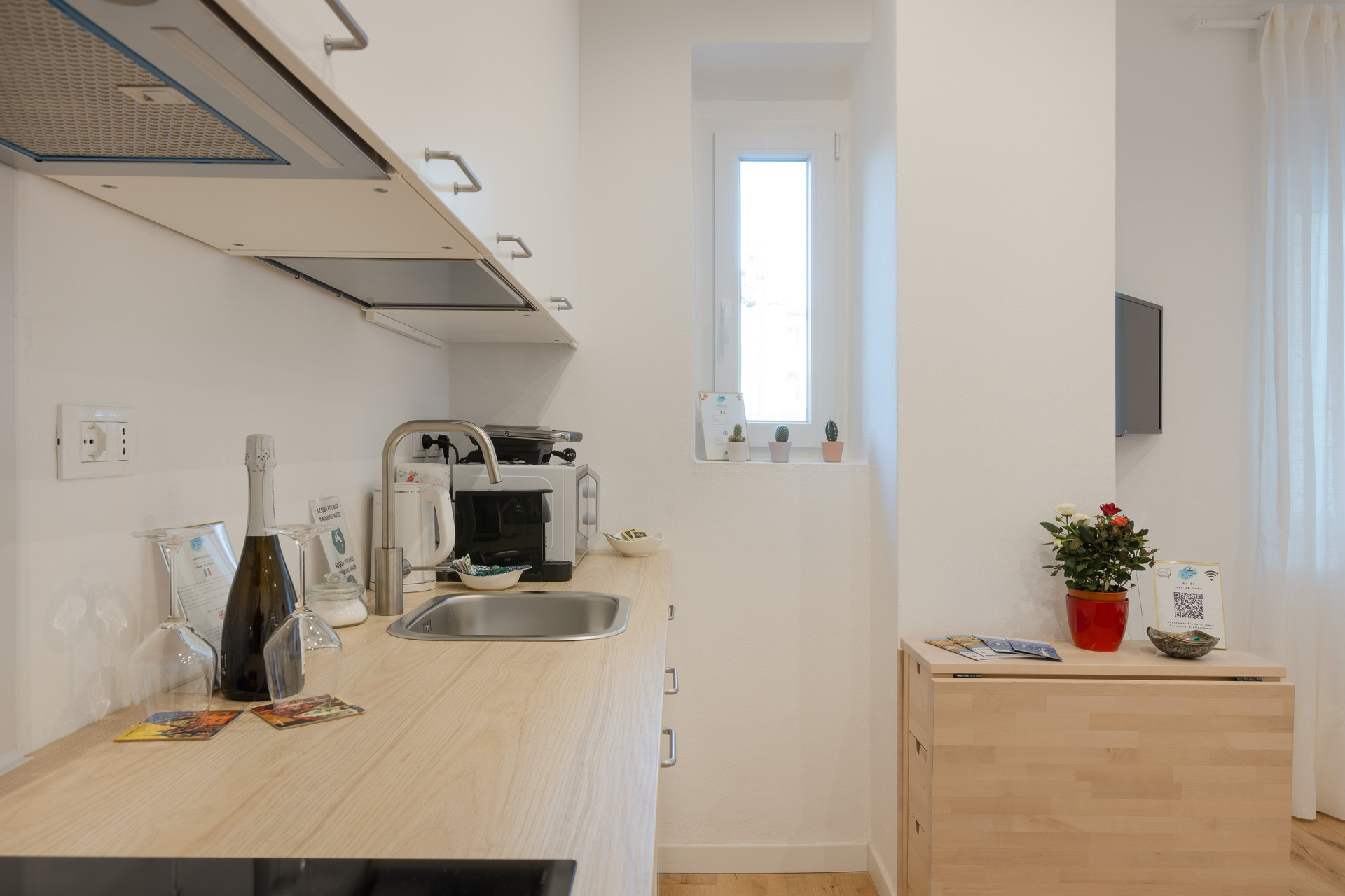 Kitchen counter with appliances and TV