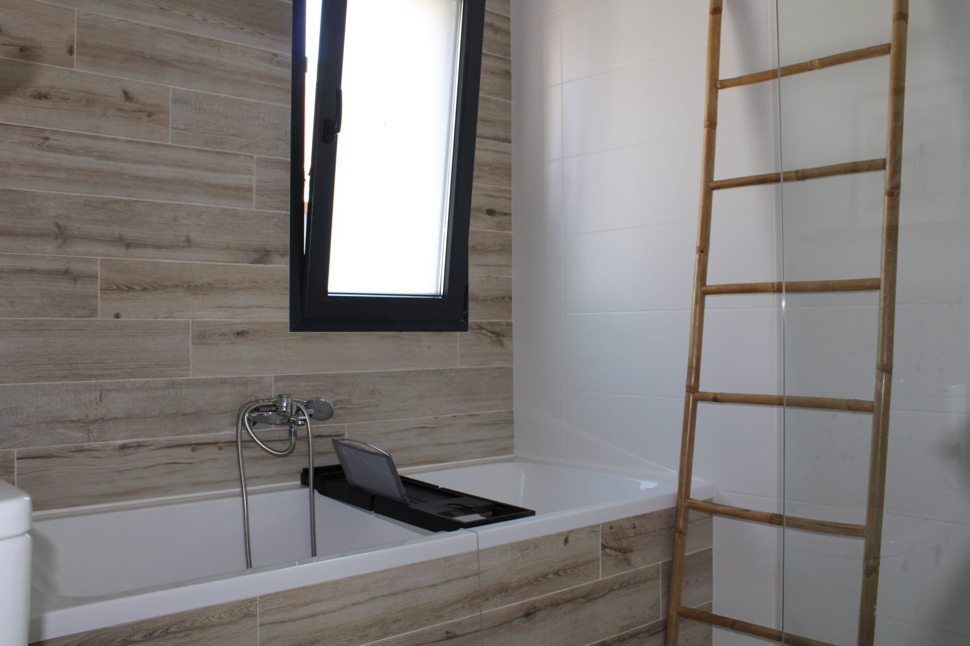 Bathroom with wood tile and tub