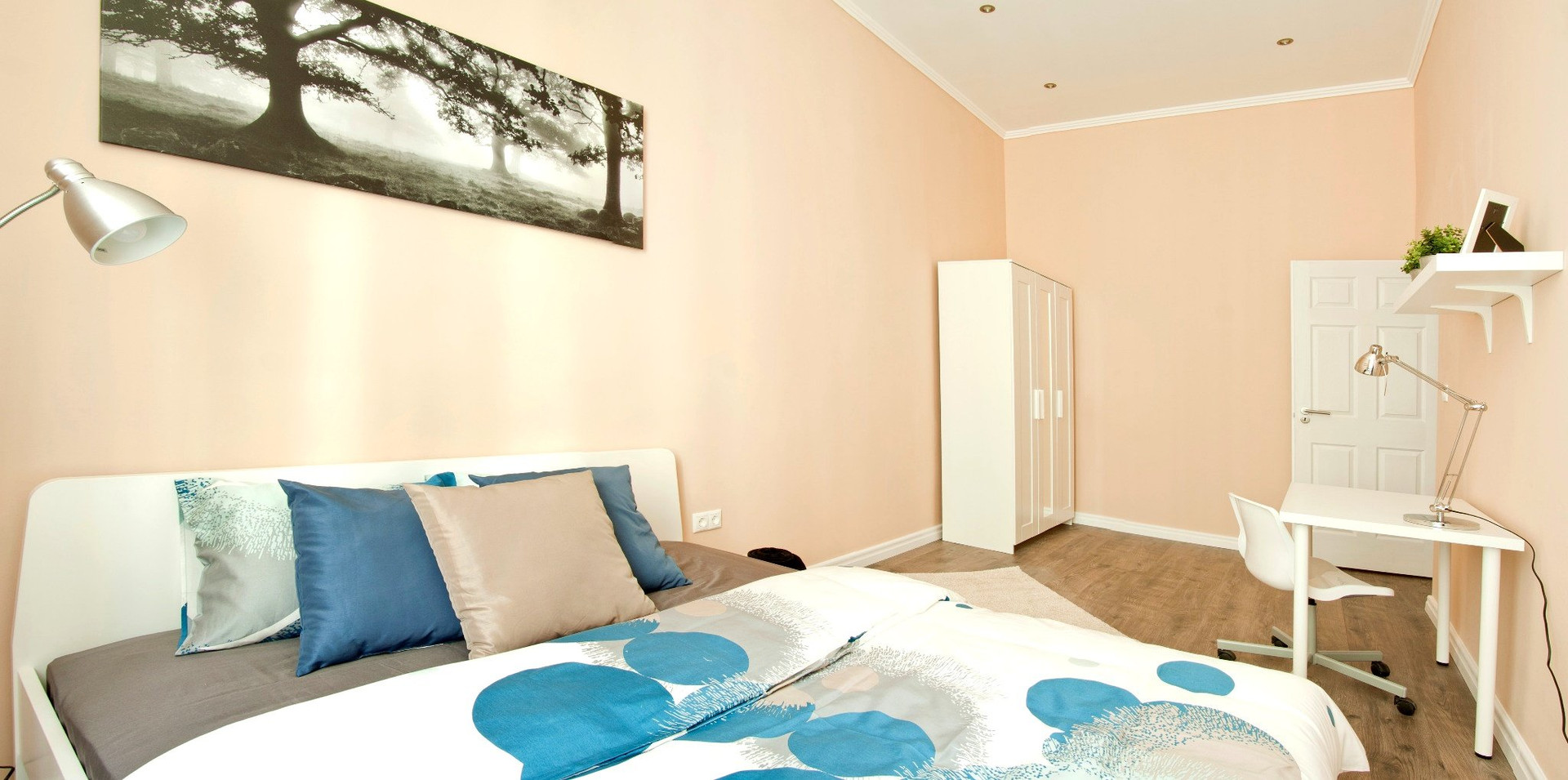 Spacious room with high ceilings and a practical layout designed for comfortable long-term stays.