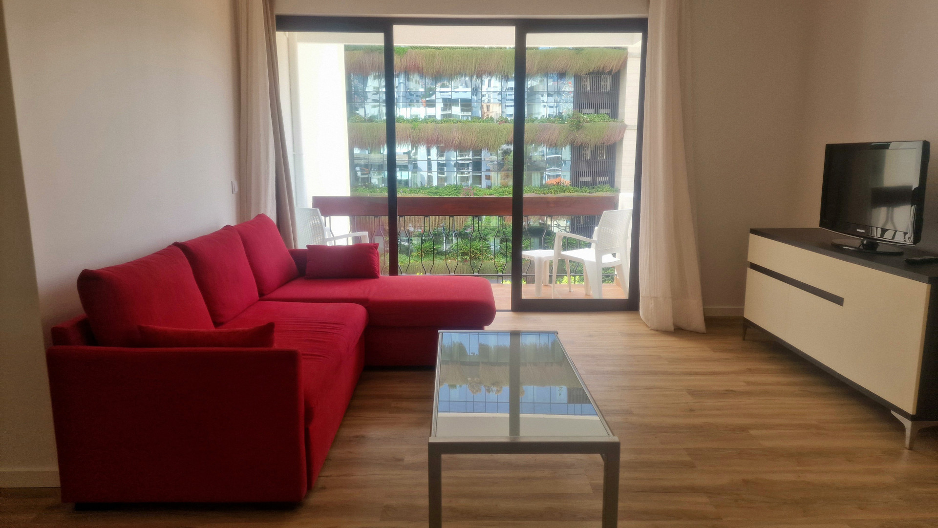Living room with red sofa and TV