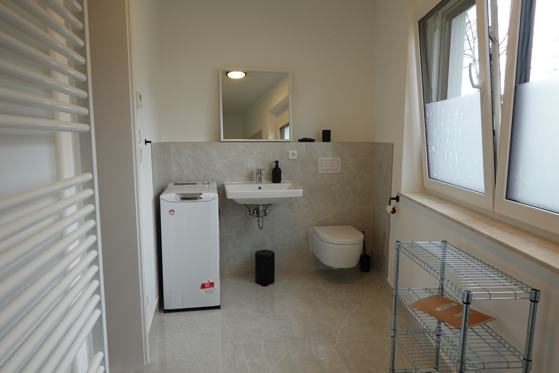 Bathroom with toilet and washer