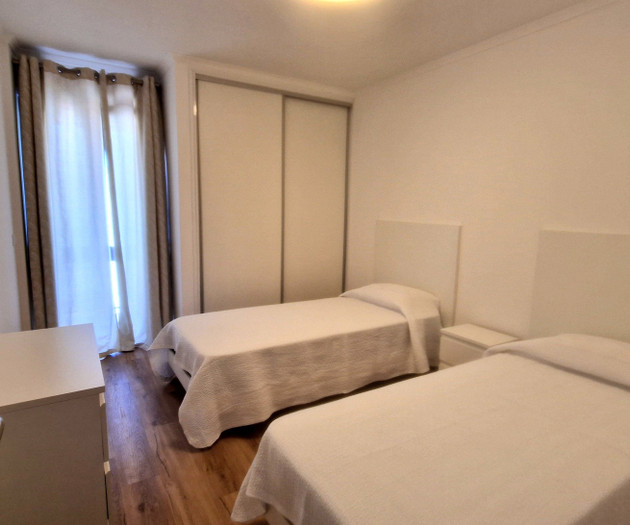 Twin bedroom with wardrobe and window