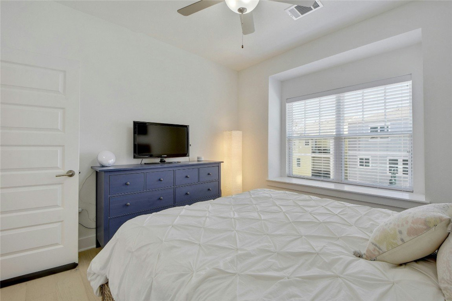 Bright bedroom with blue dresser