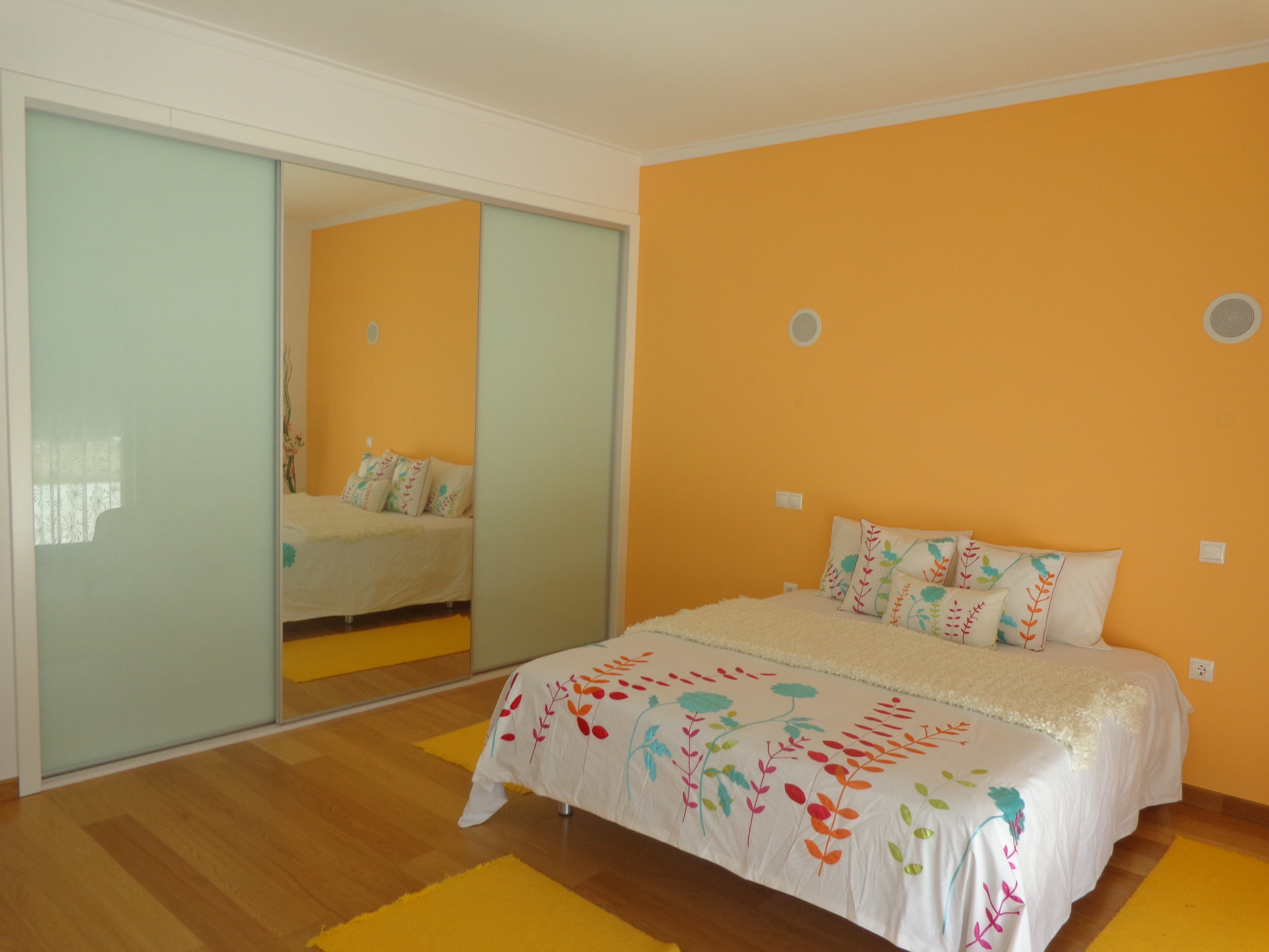 Orange bedroom with double bed