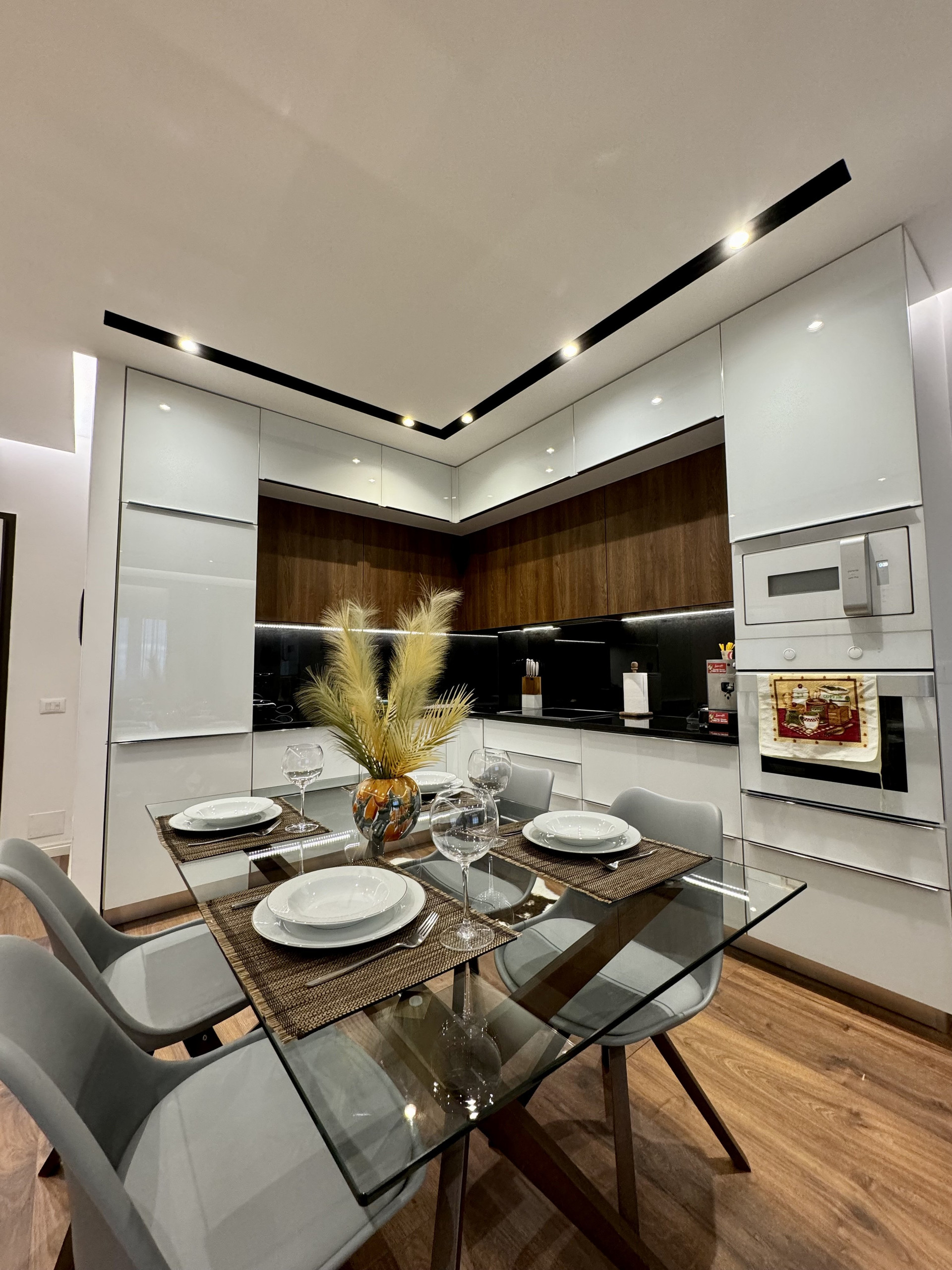 Modern kitchen with glass dining table
