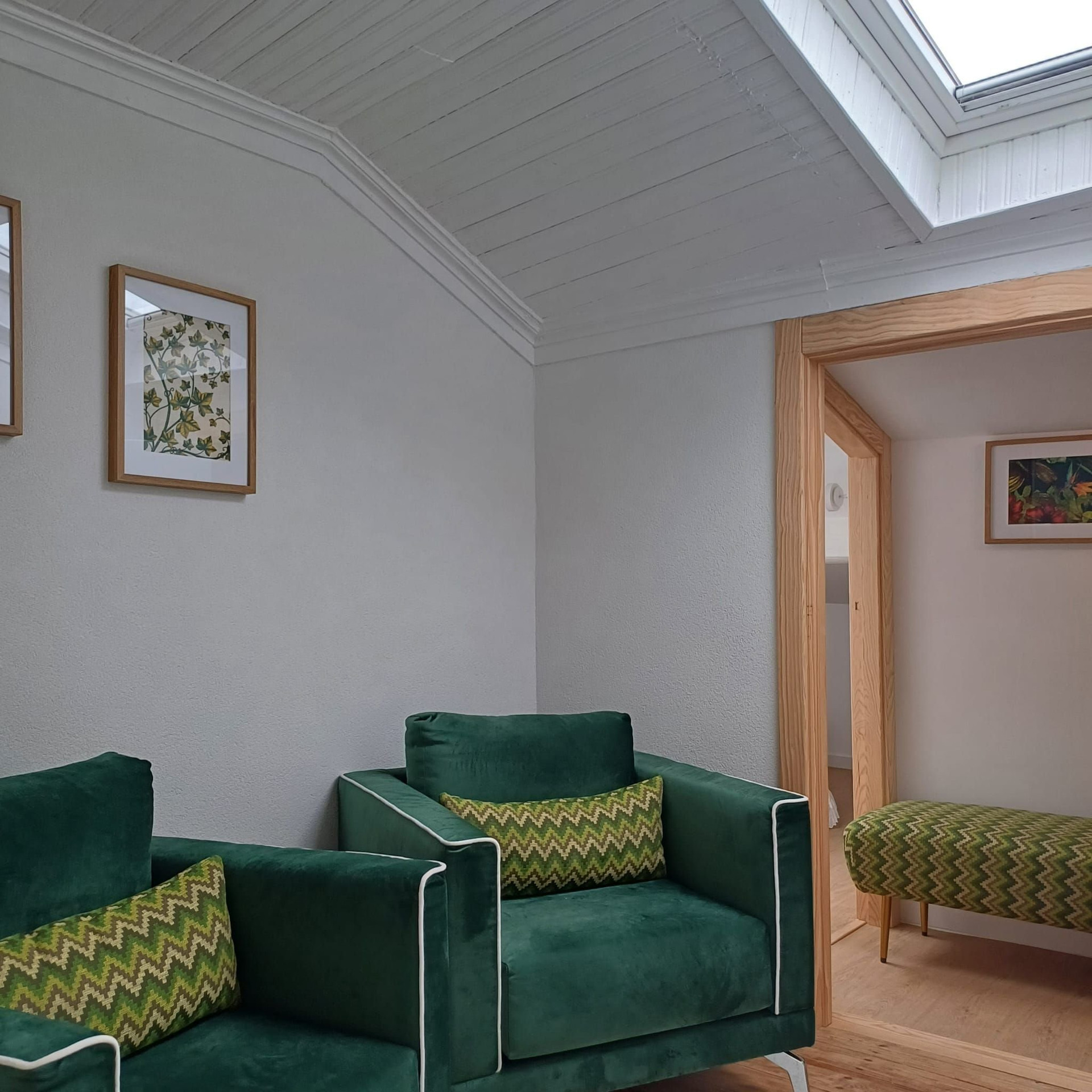 Upstairs lounge with green armchairs