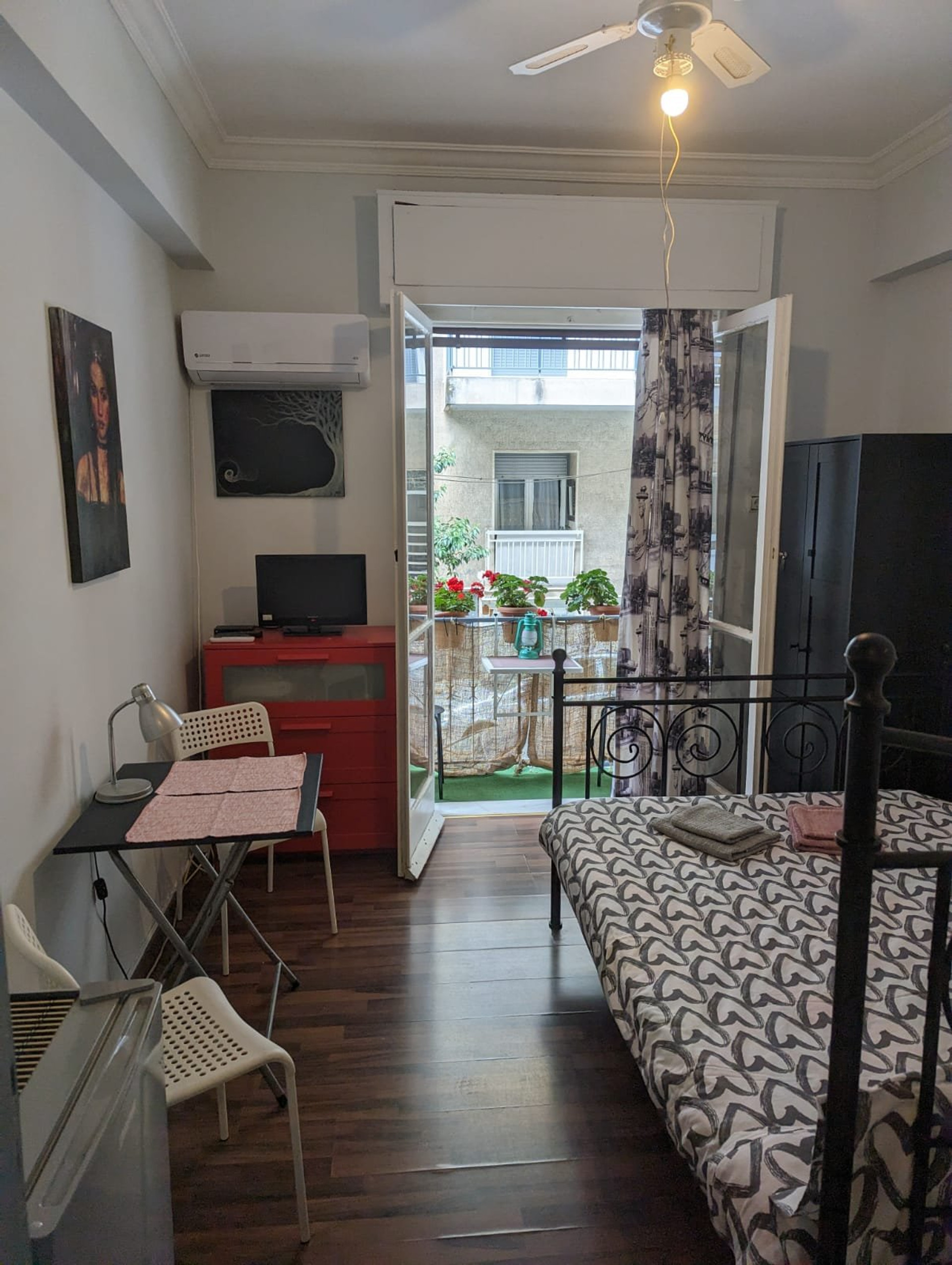 Bedroom with balcony and TV