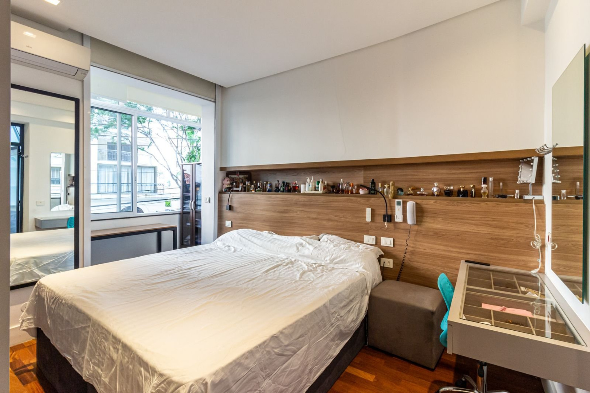 Bedroom with wooden headboard and desk