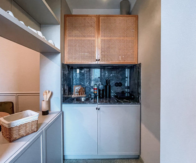 Kitchenette with rattan cabinets