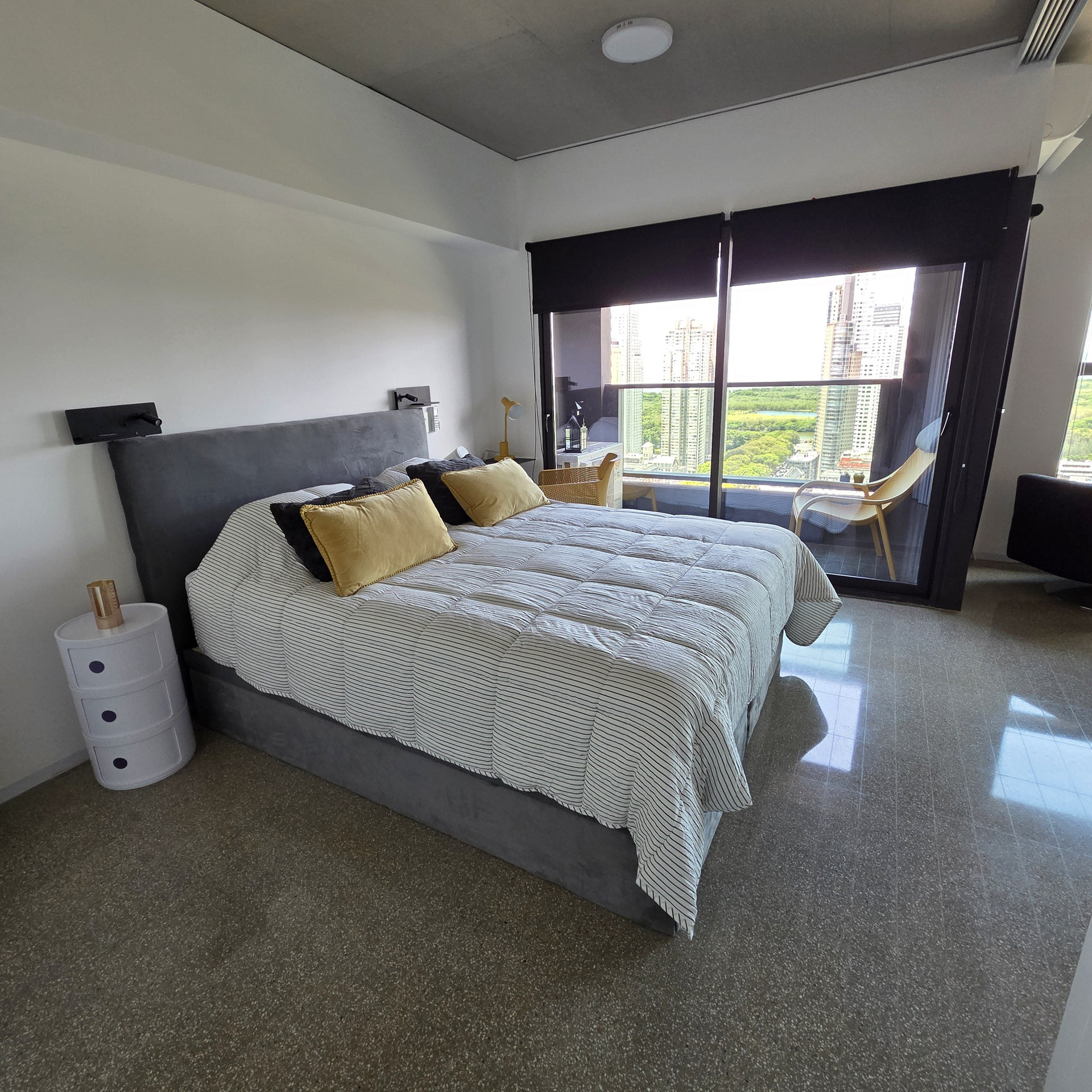 Bedroom with striped bedding and balcony