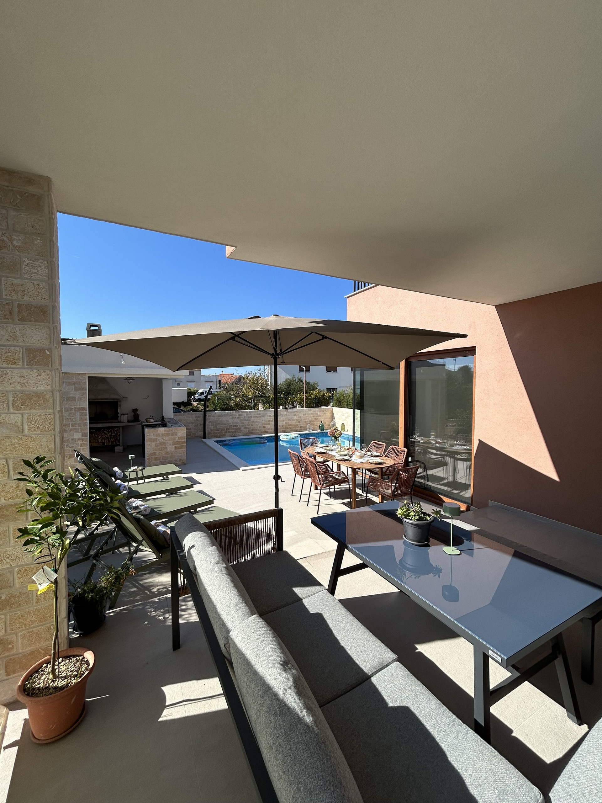 Terrace with outside kitchen lounge set, sunterrace and private pool