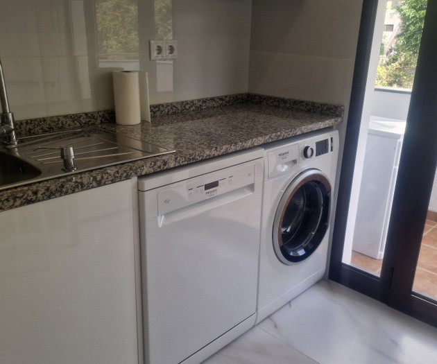 Laundry area with washer and sink