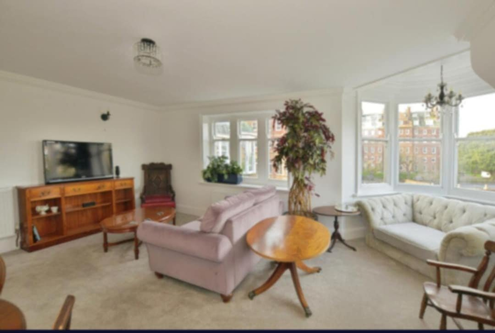 Living room with TV and bay window