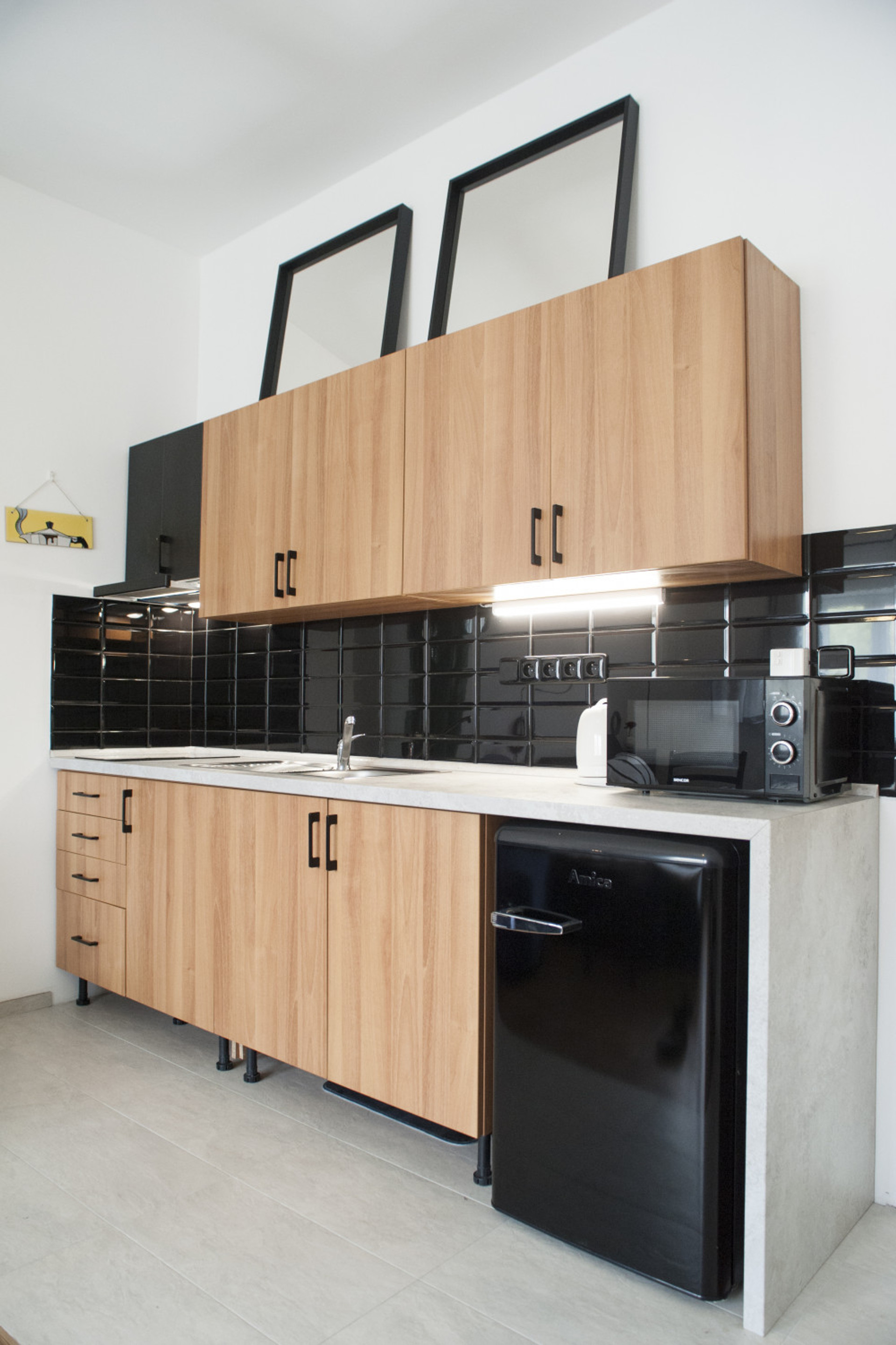 Kitchenette with microwave oven, fridge & freezer, kettle, two rings hob, fan, and dishes, forks&knives, pots, pens and all neccesities needed for cooking