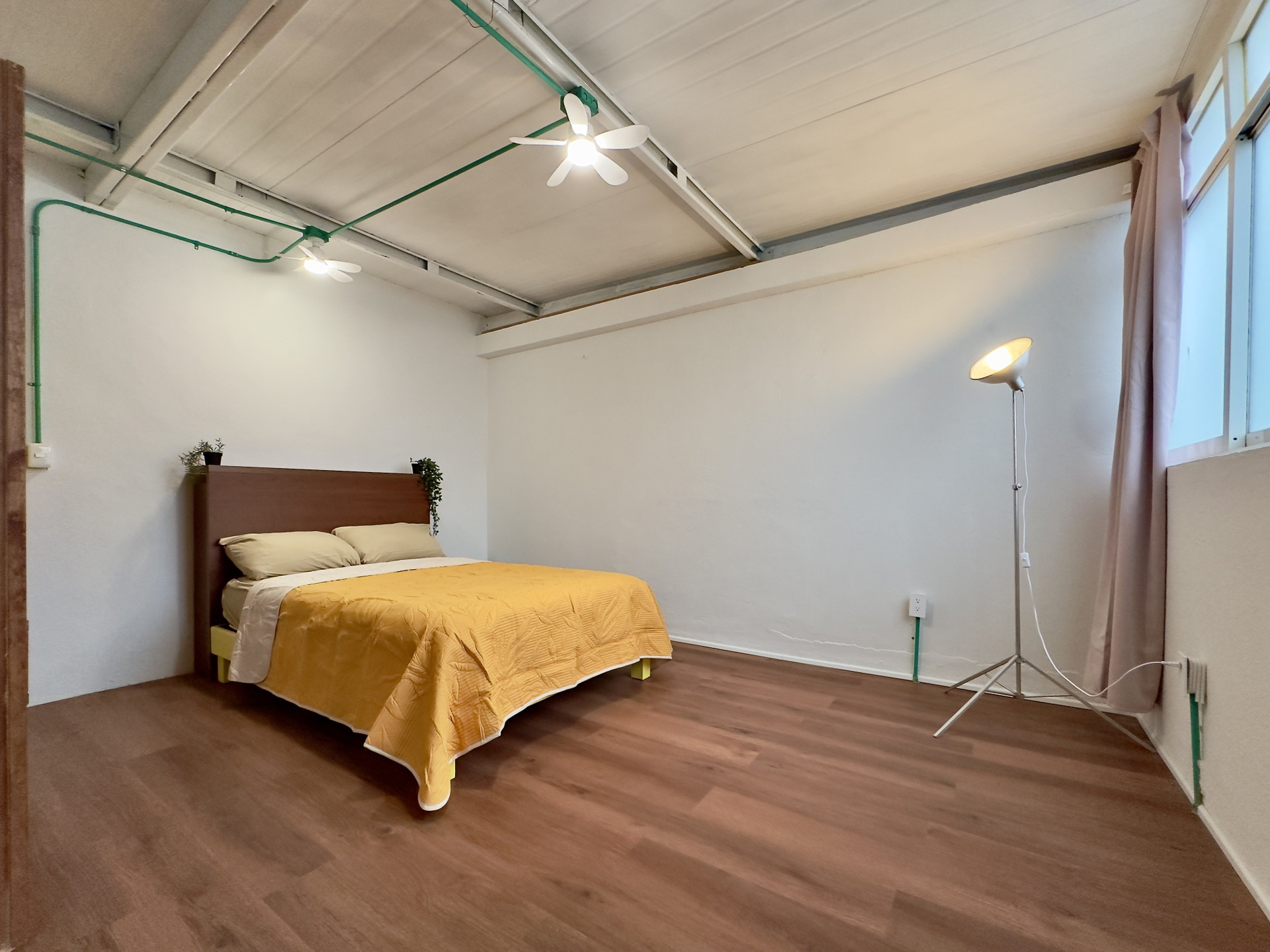 Spacious bedroom with wood floor