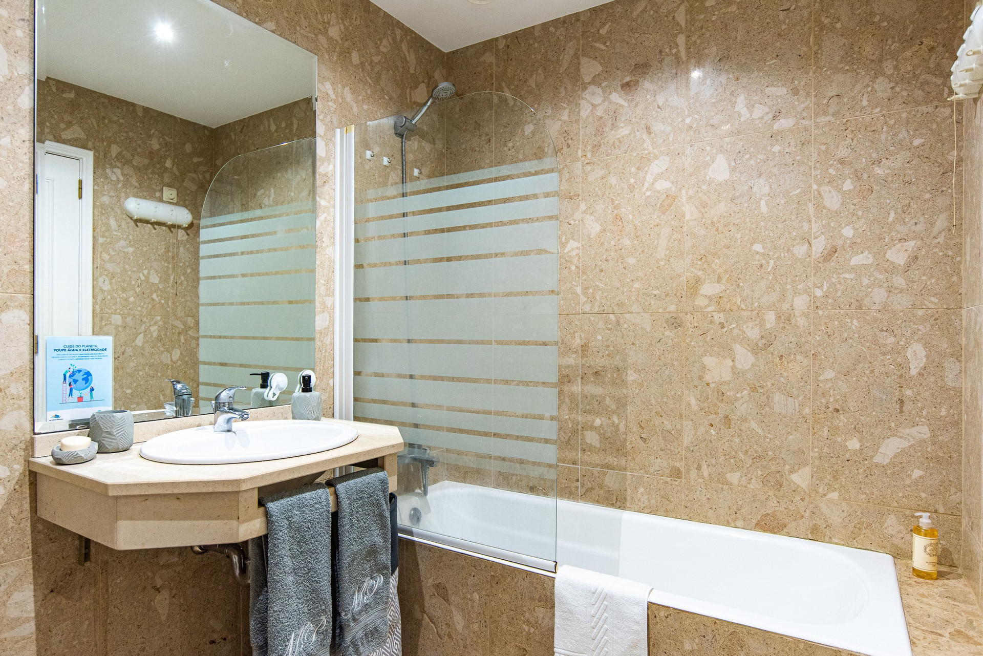 Bathroom with tub and shower screen