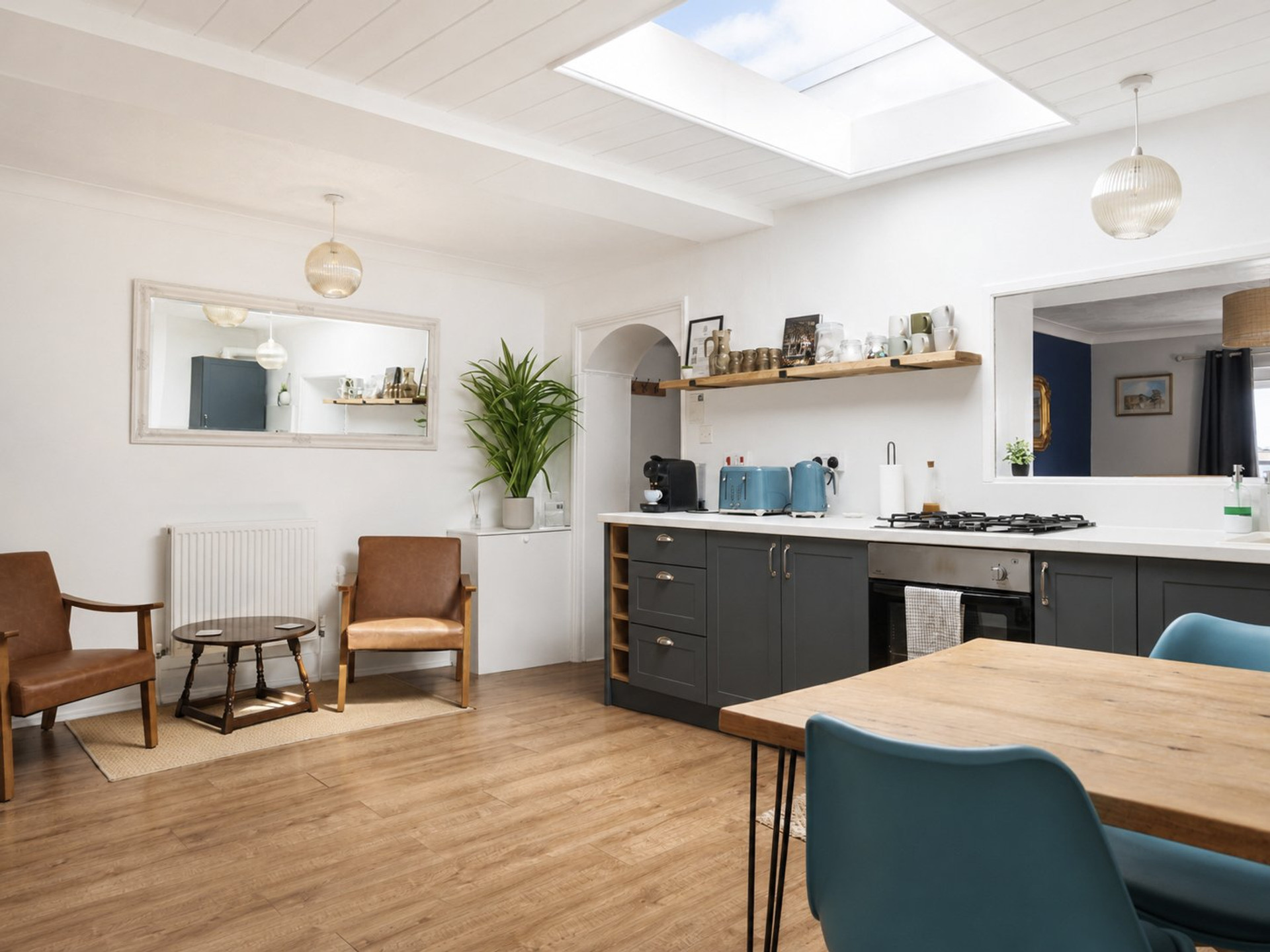 Open kitchen with skylight and seating