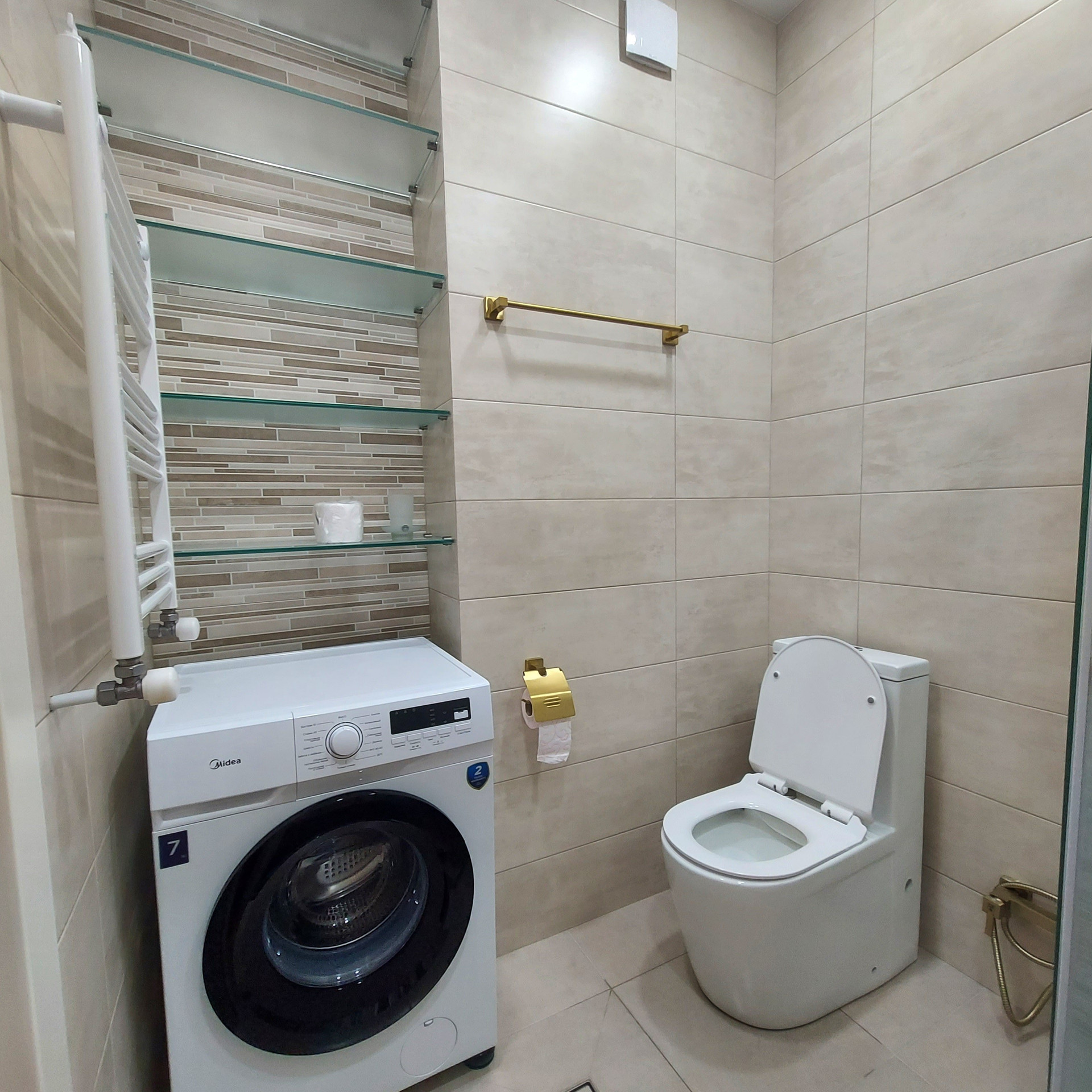 Bathroom with shower and washing machine