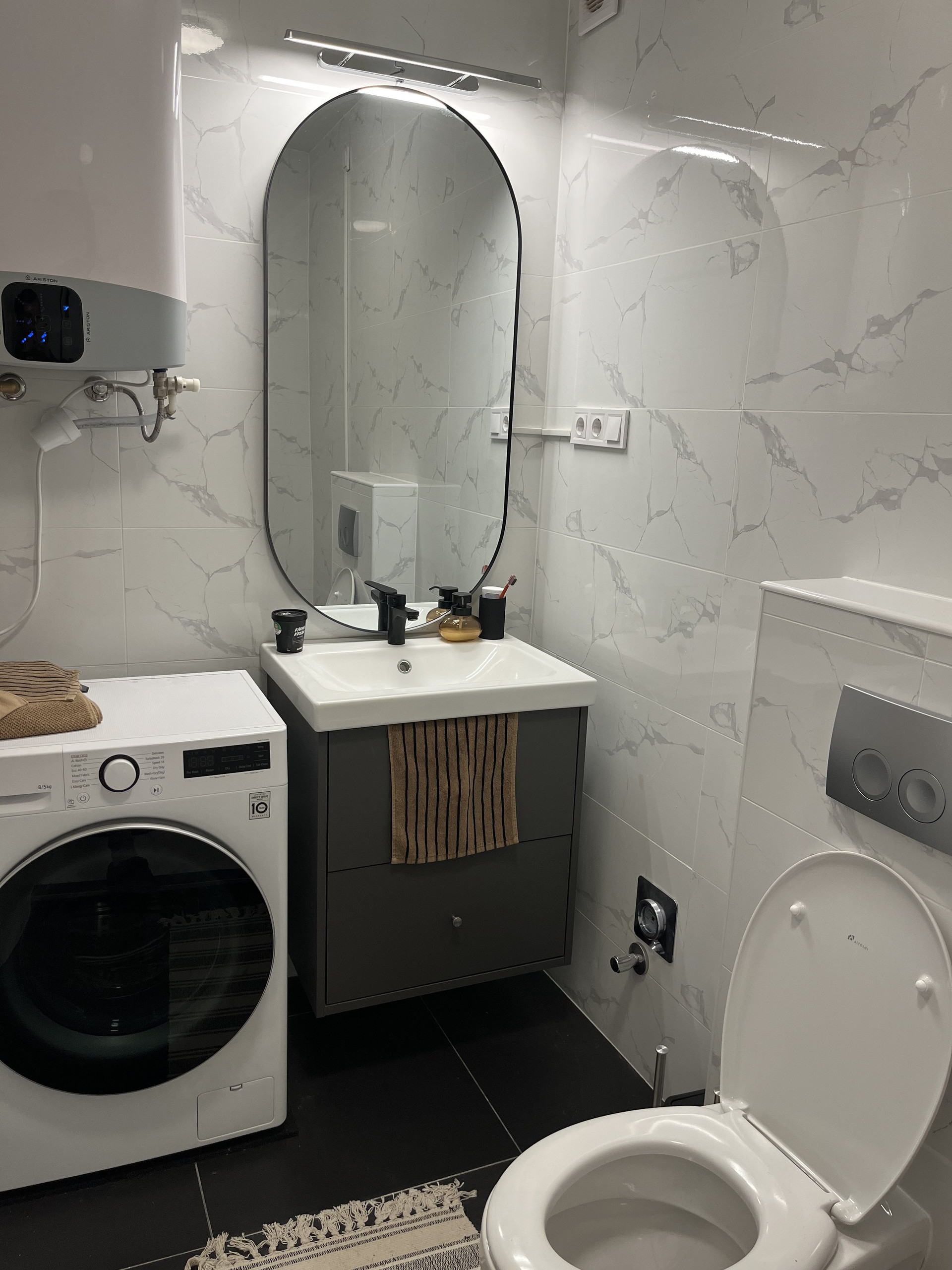 Bathroom with washer and mirror