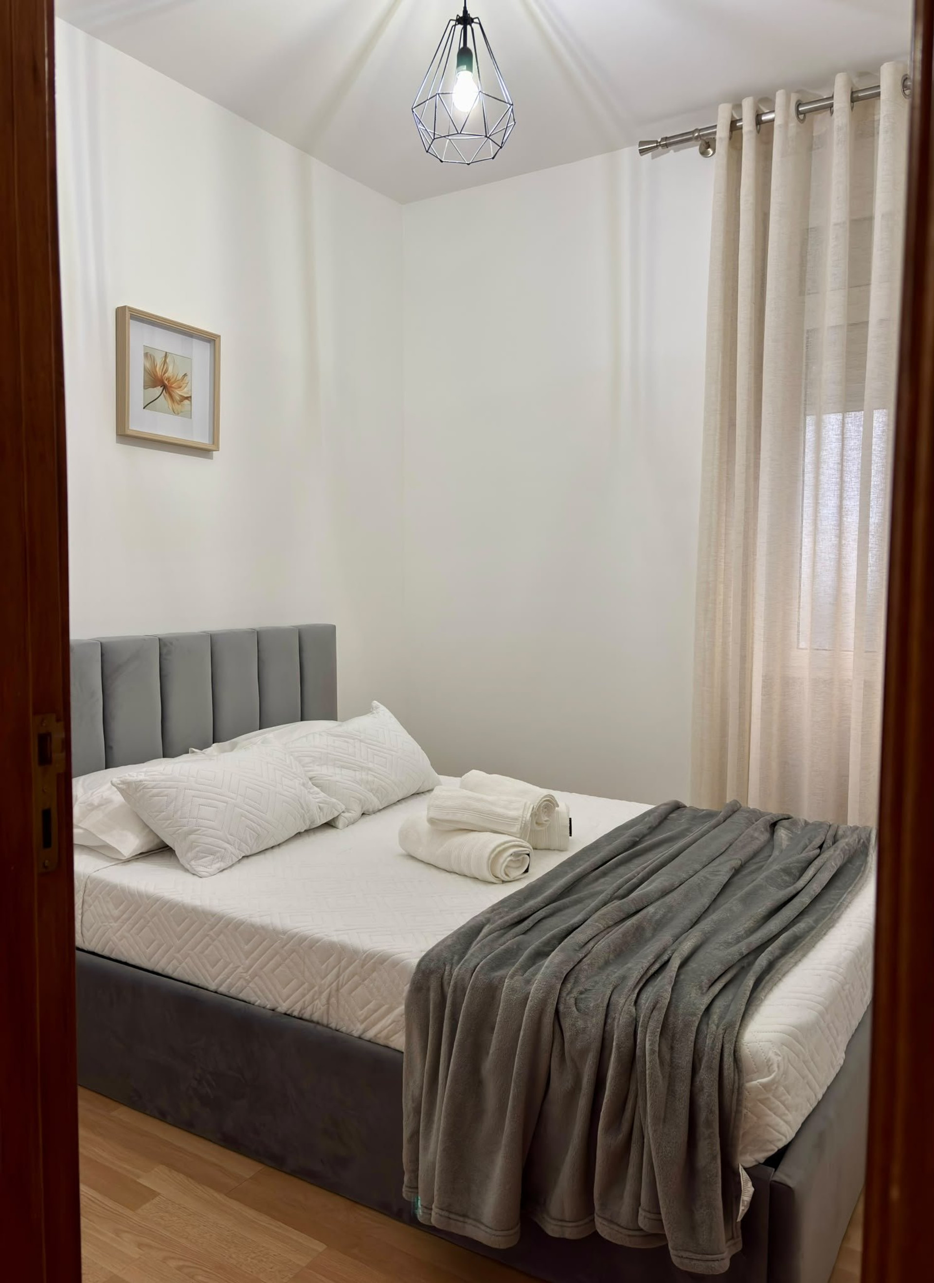 Second bedroom with grey headboard