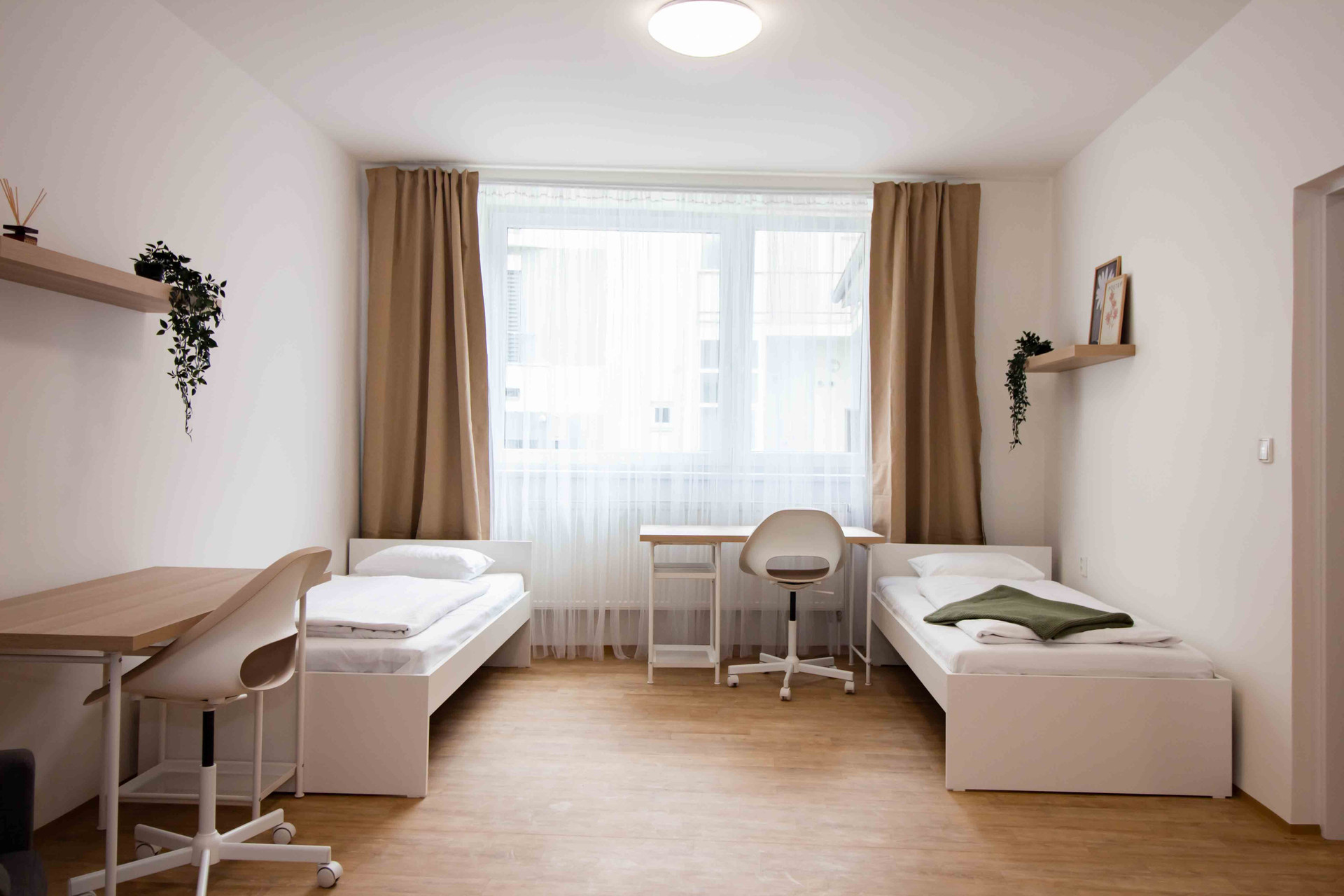 Twin bedroom with desks and window