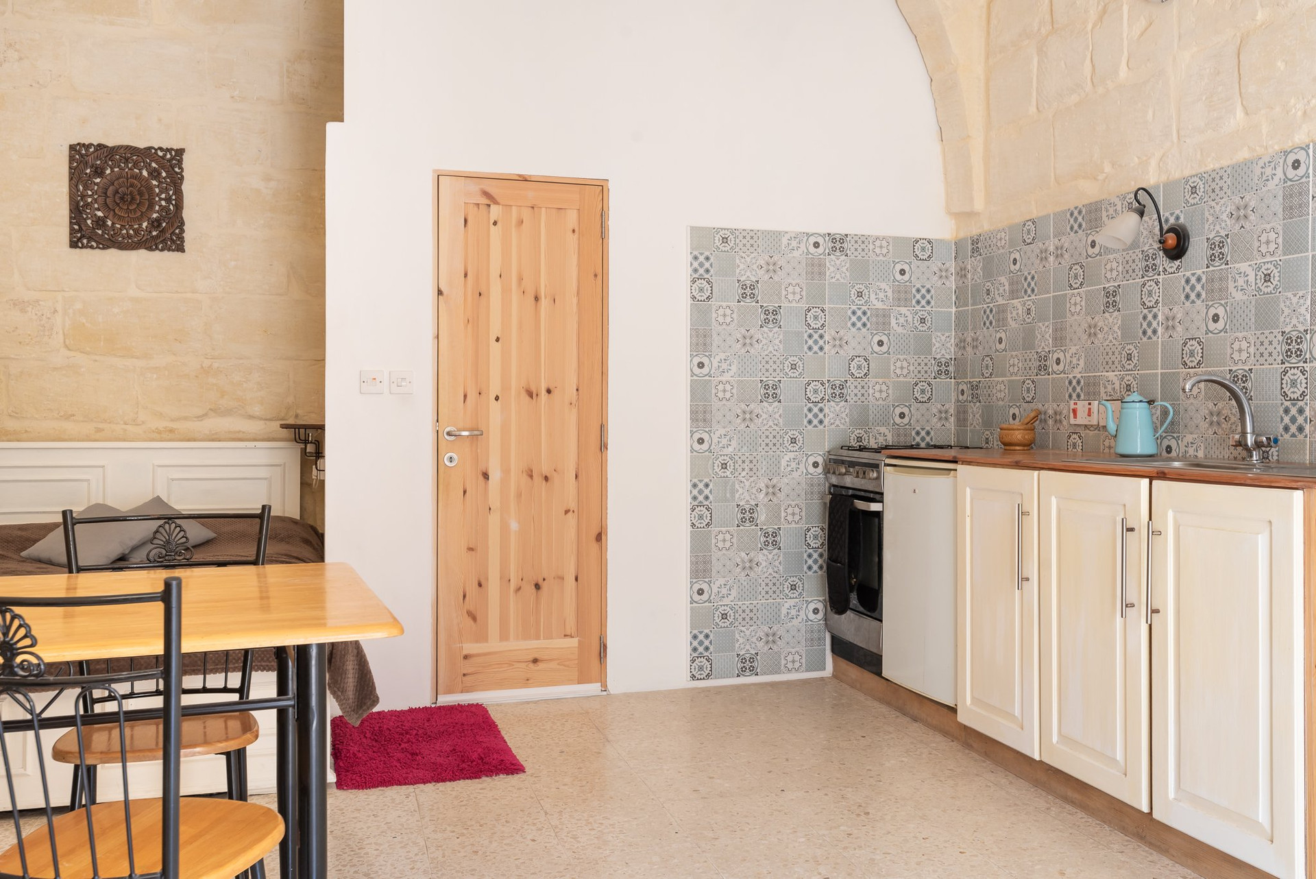 Kitchen with stone walls and door