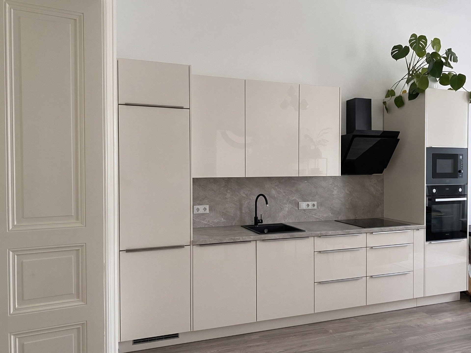 Modern kitchen with glossy cream cabinets