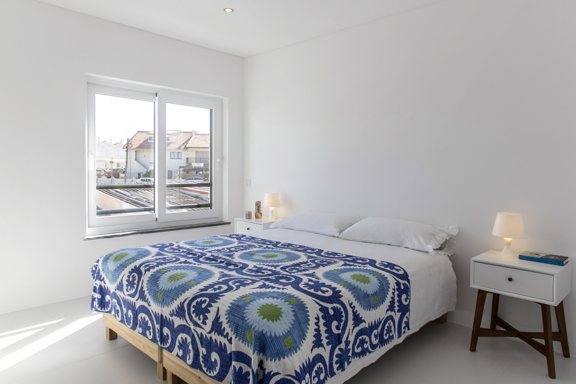 Bedroom with blue patterned bedspread
