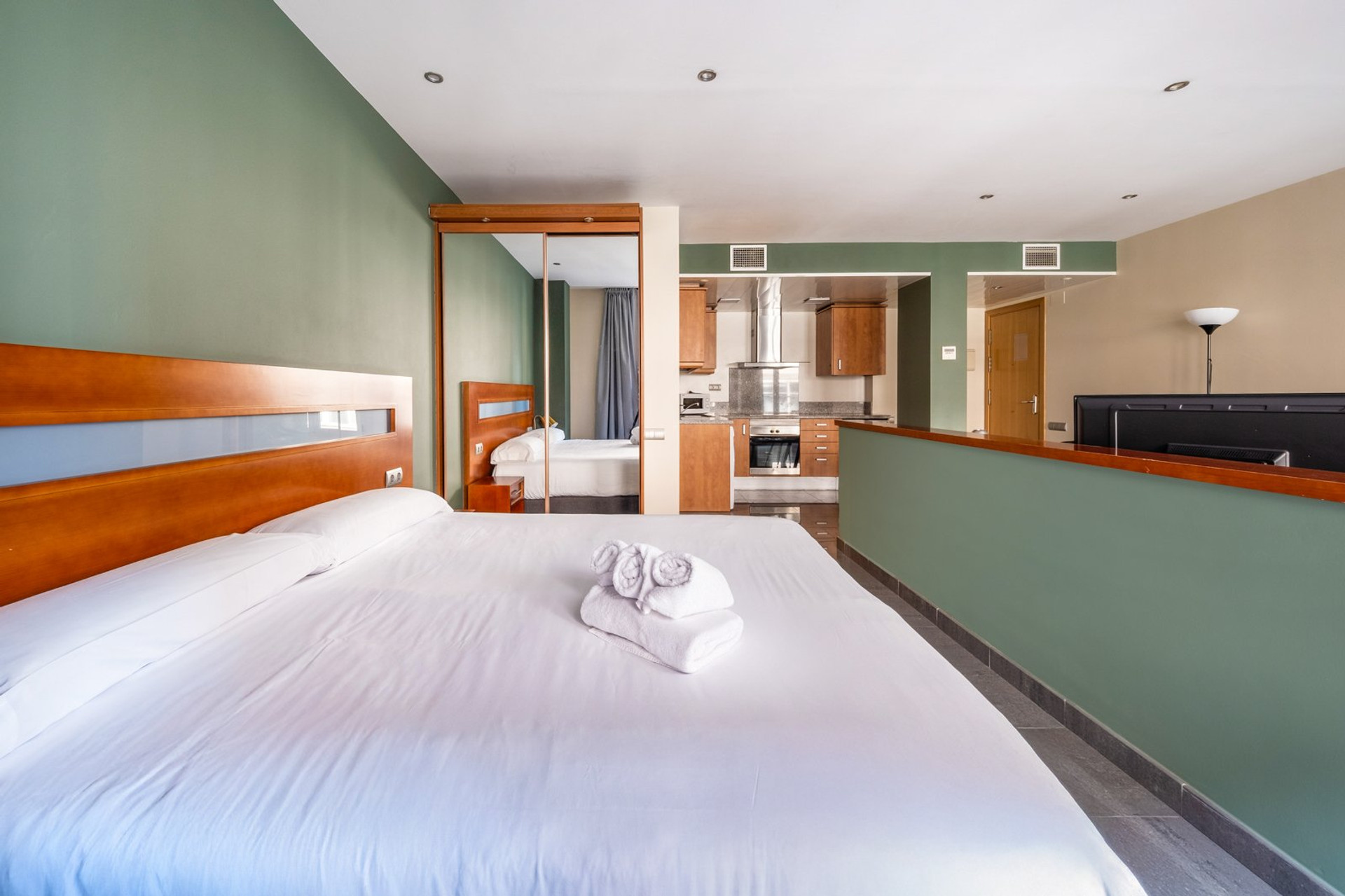 Double bed with kitchen behind