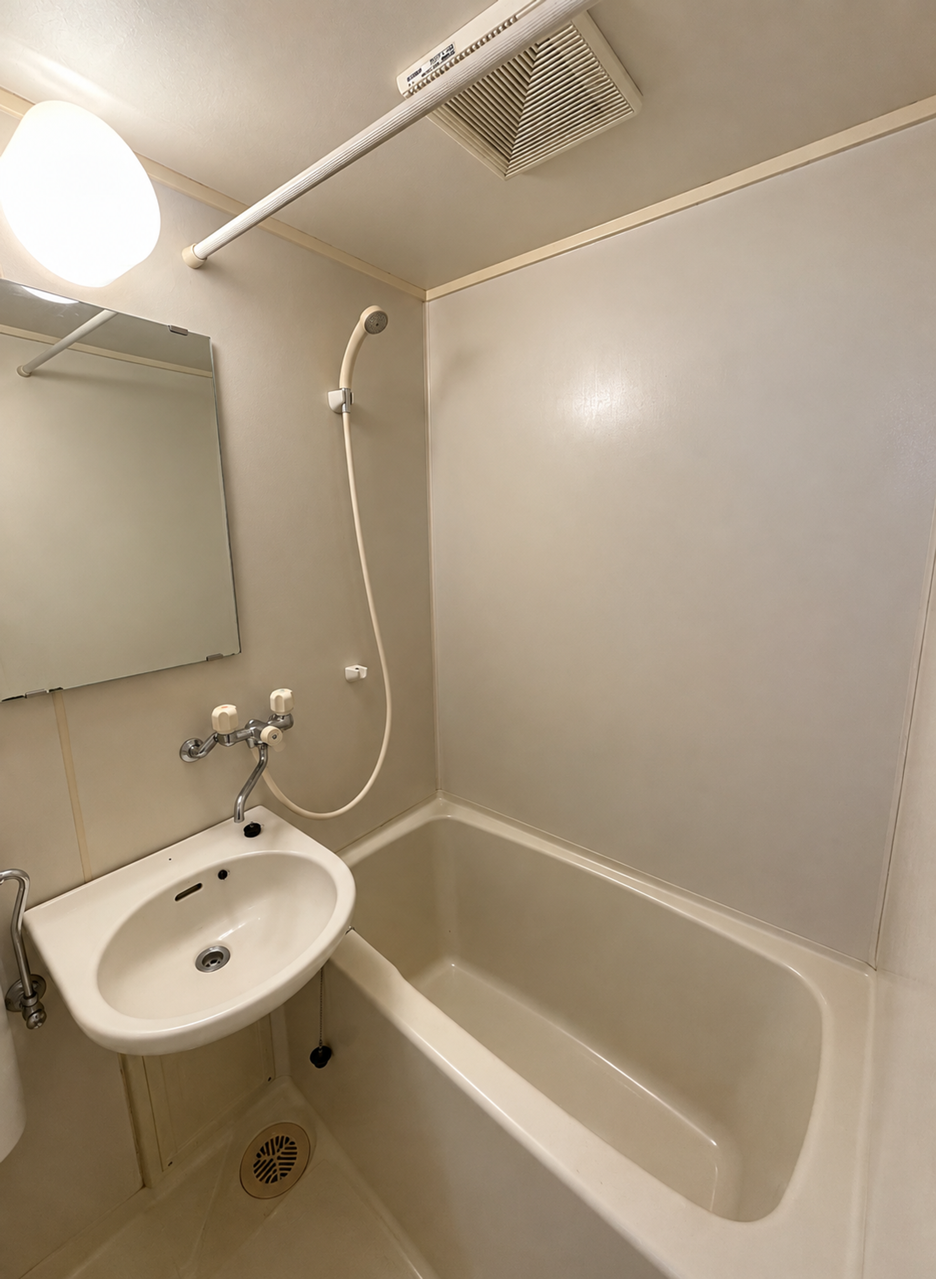 Compact bathroom with tub and sink