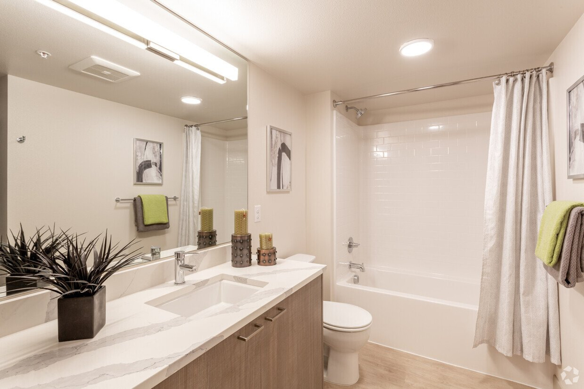 Bathroom with tub and quartz vanity