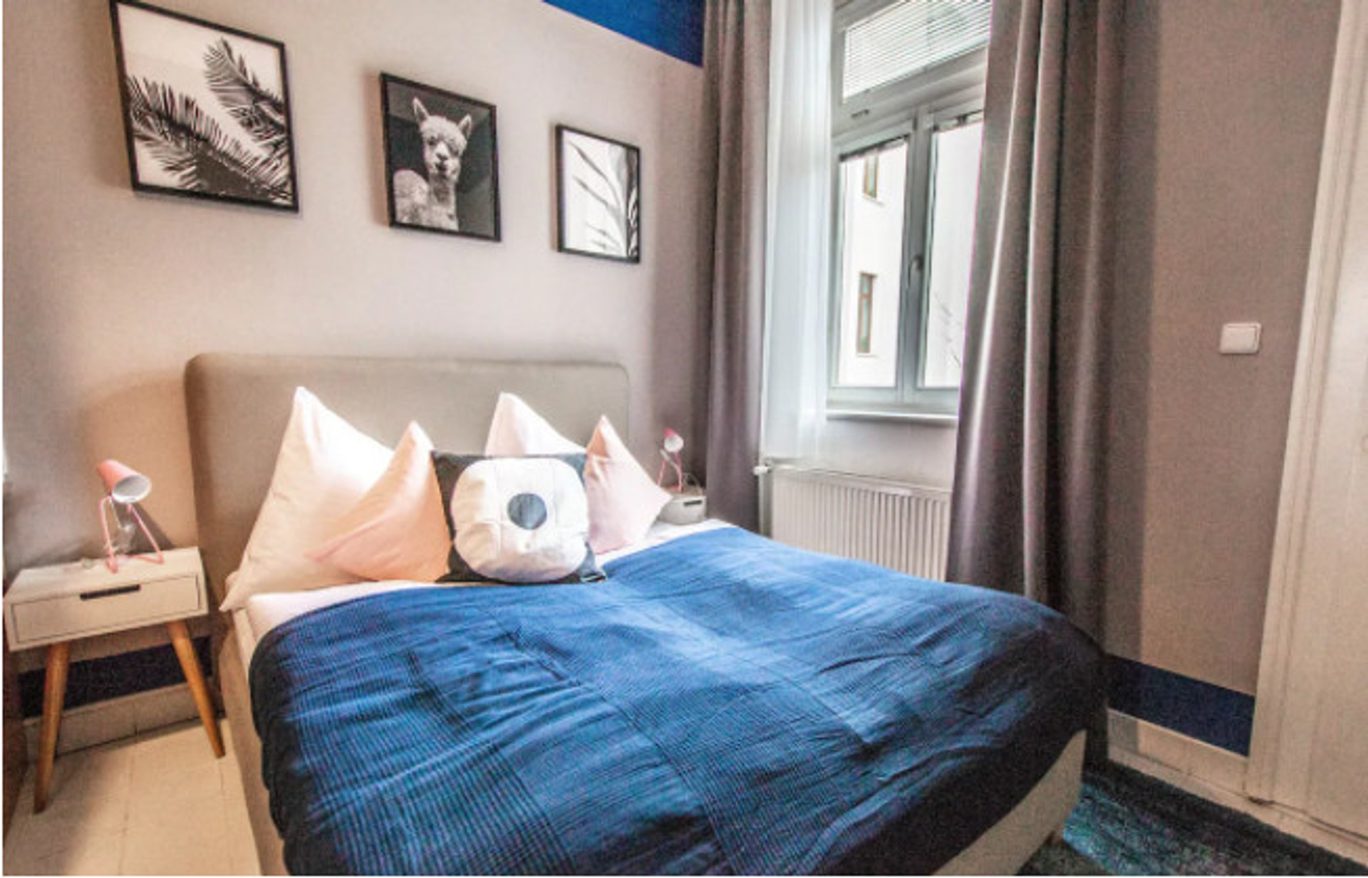 Sleeping area in the 1st room with a queen bed (160cm) and bed side tables.