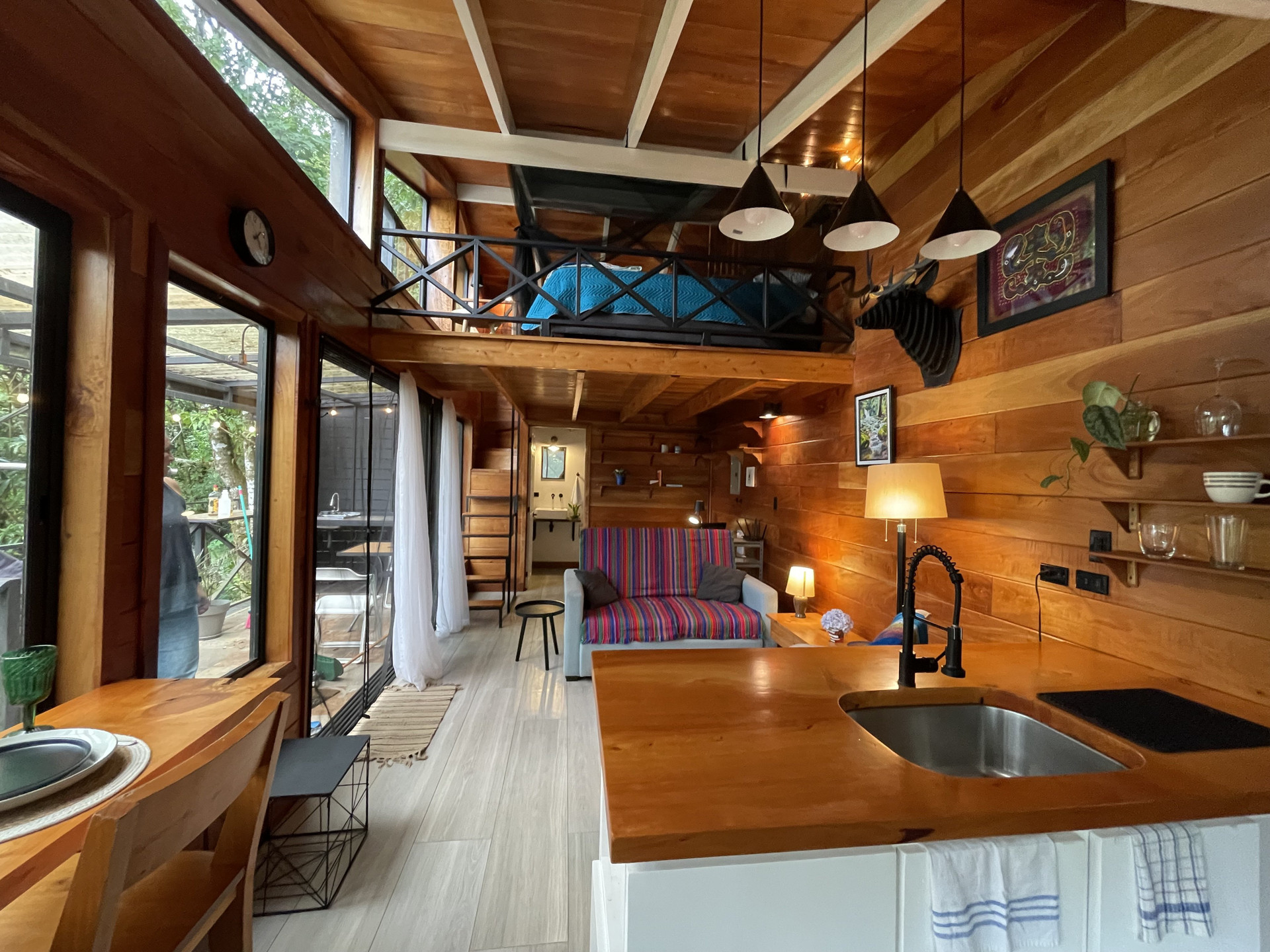 Open-plan cabin living area with loft