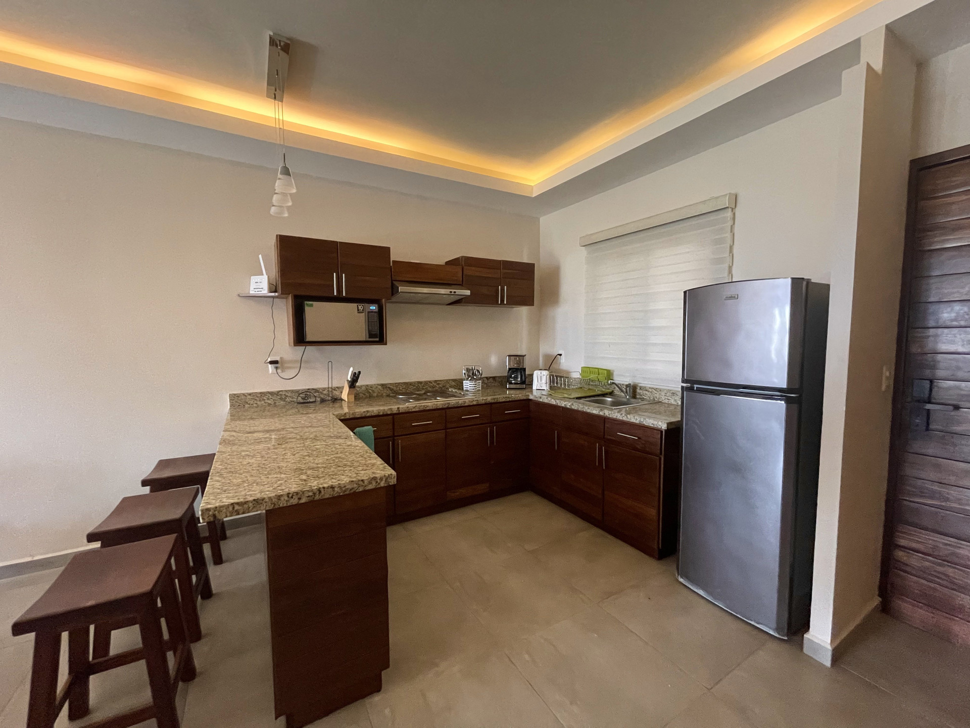 Kitchen with bar counter and refrigerator
