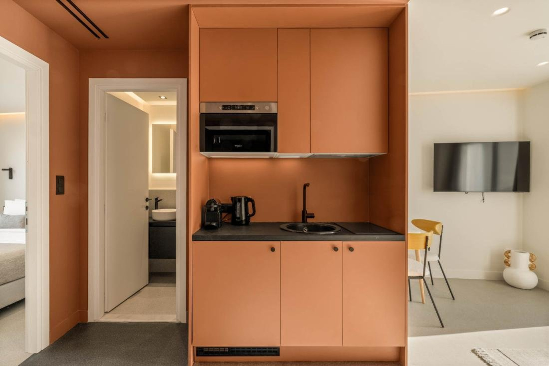Orange kitchenette with modern appliances