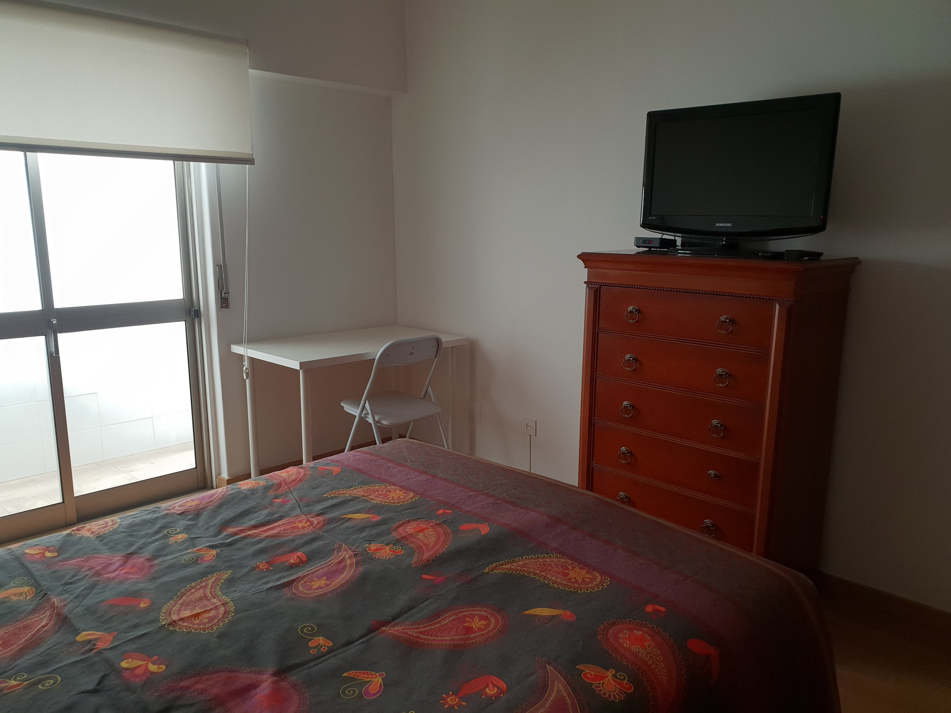 Bedroom with desk and TV