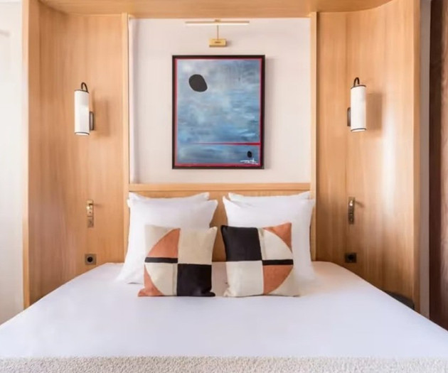 Bedroom with wood headboard and art