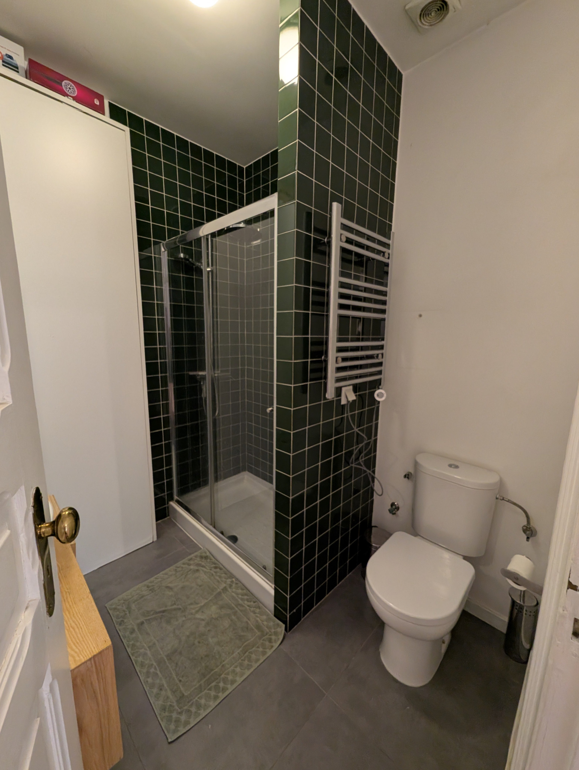Bathroom with green tiles and shower