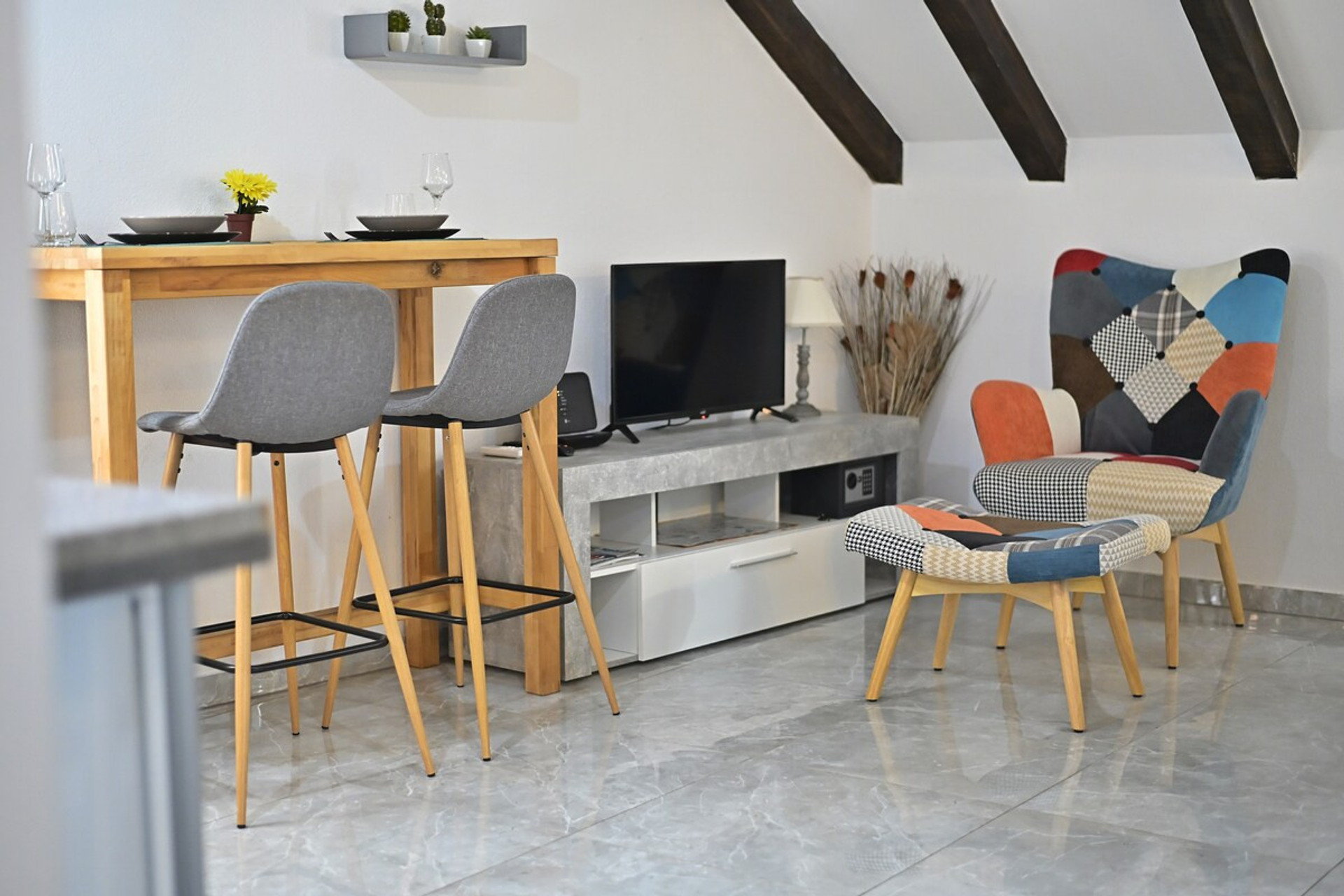 Colorful armchair and TV in the living area.