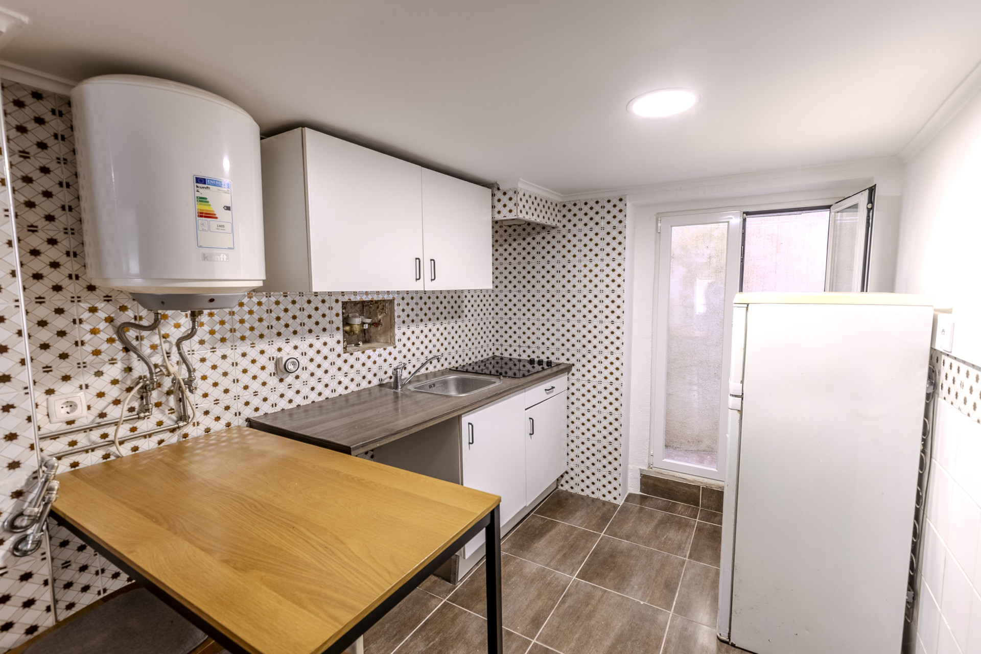 Kitchen with water heater and cabinets