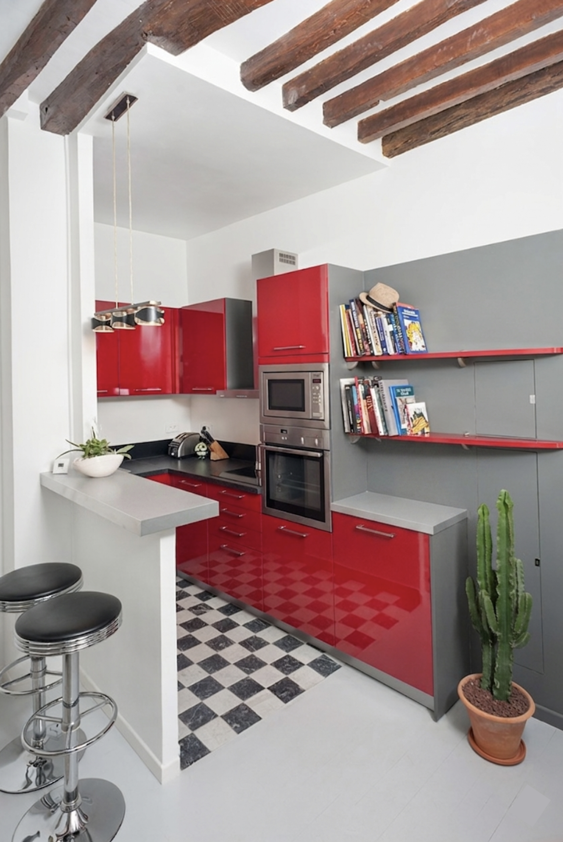 Modern kitchen featuring a stylish breakfast bar and unique exposed wooden beams