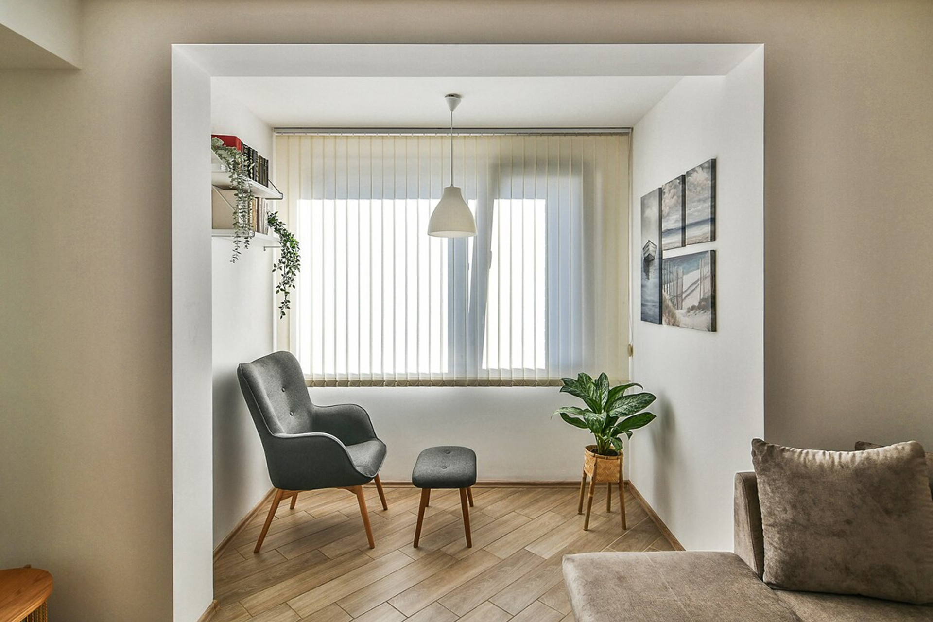 Relaxing reading nook with natural light – A cozy corner by the window, complete with a modern armchair, soft lighting, and indoor greenery. The perfect space to unwind with a book or enjoy a cup of coffee.