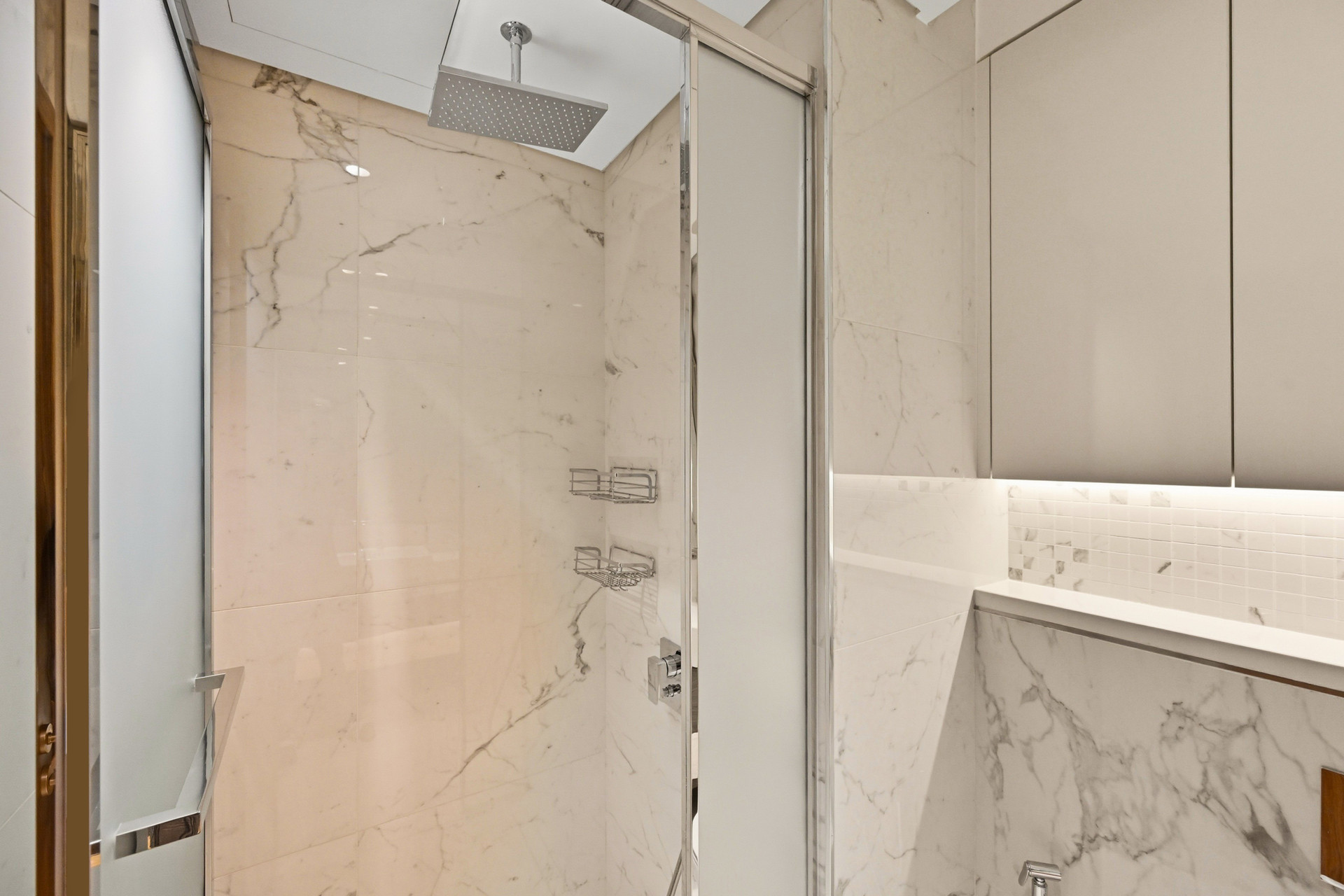 Glass-enclosed shower with rainfall showerhead
