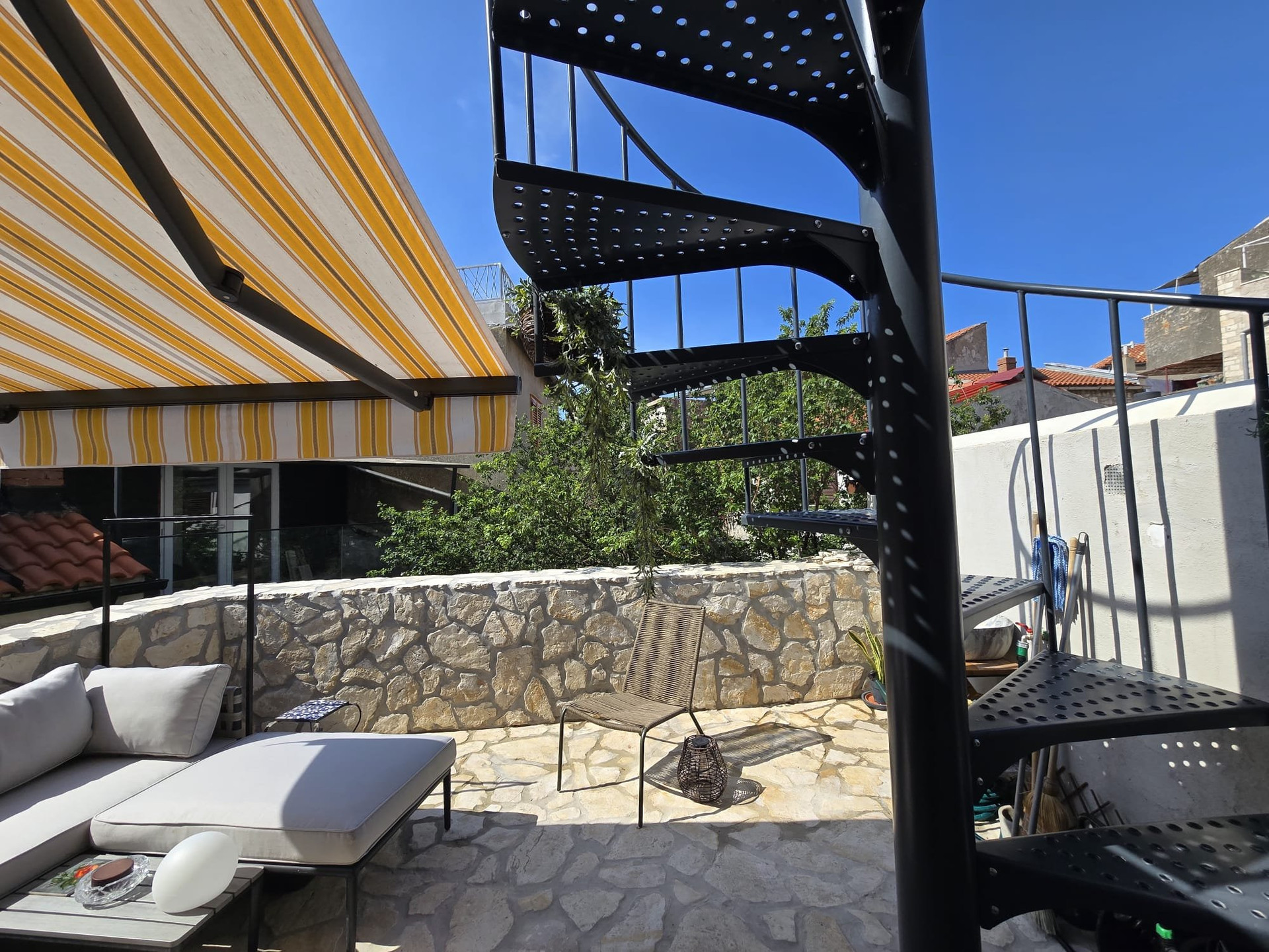 Stone courtyard terrace with spiral staircase