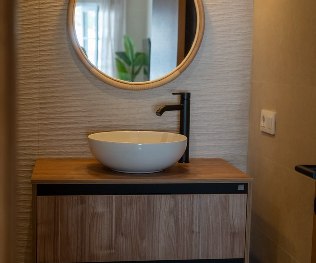 Round mirror above vanity sink