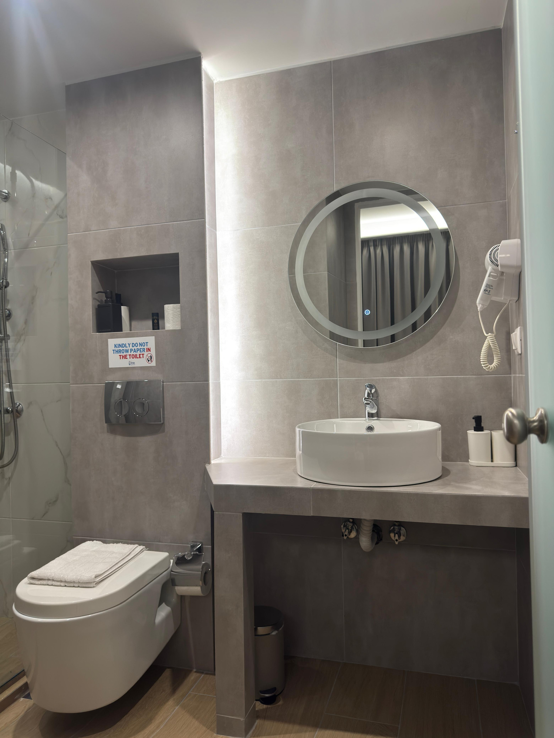 The private bathroom is functional and aesthetically pleasing.